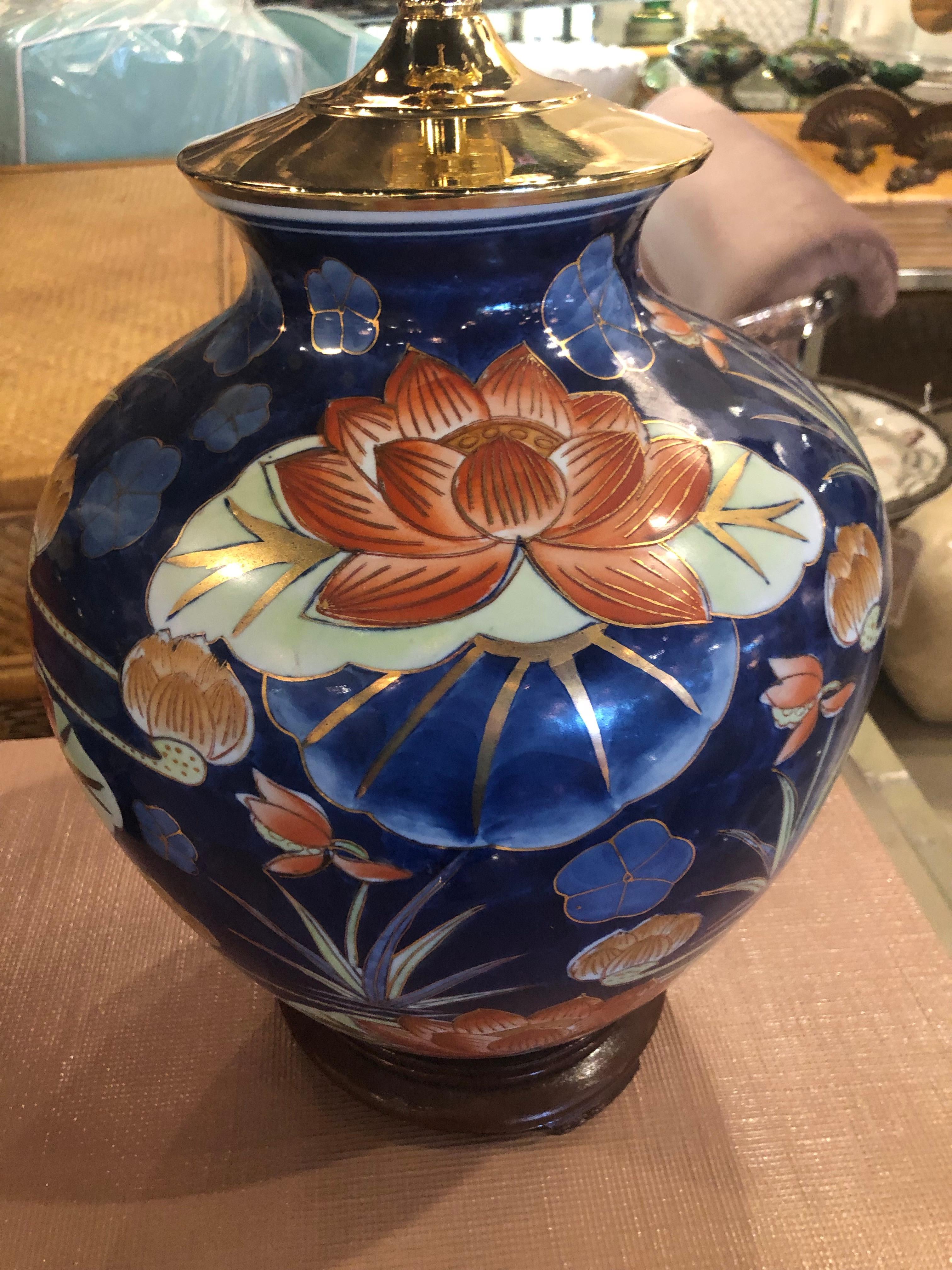 Vintage chinoiserie pair of navy blue & orange lotus flower ceramic table lamps. Brass pagoda tops, wood base. All new wiring and brass sockets. No chips or breaks.
Lamps are 25.5 H to top of finials
18.5 H to socket.