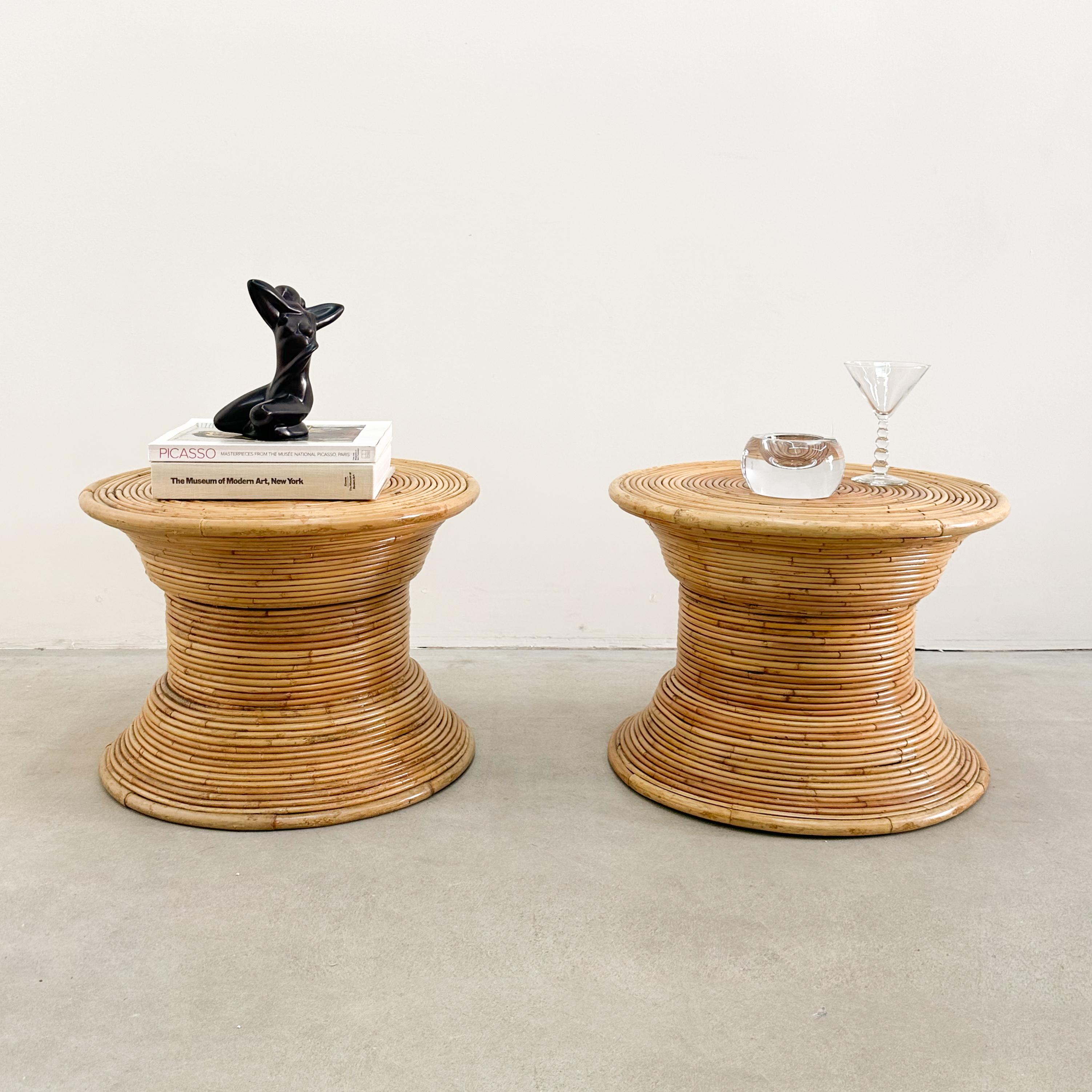 This pair of vintage coastal pencil reed end tables embodies organic elegance and timeless craftsmanship. The woven rattan design showcases a beautiful natural finish, making them perfect for bohemian, coastal, tropical, or Mid-Century Modern