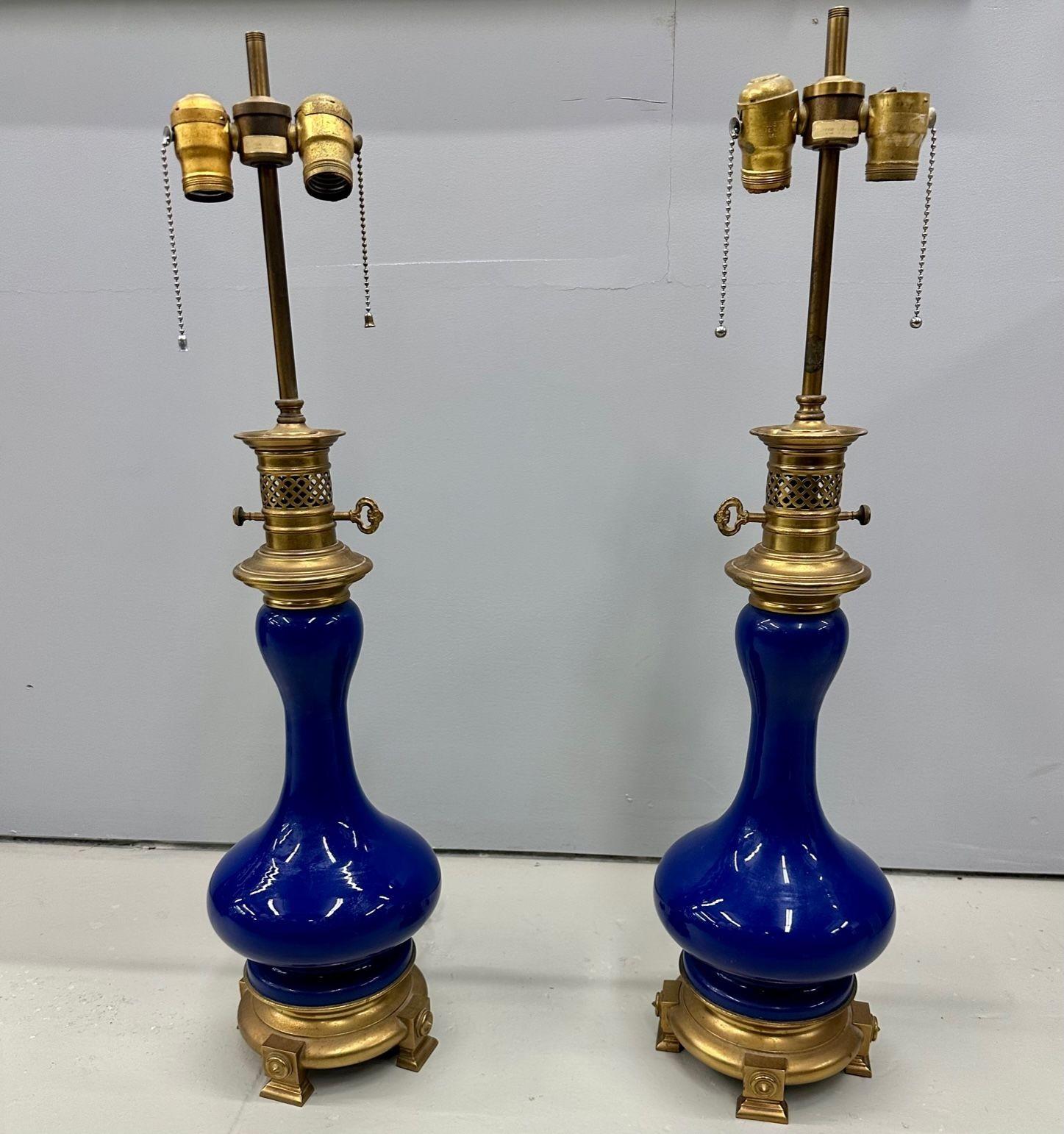 Vintage Pair of Cobalt Blue Warren Kessler Porcelain Table Lamps, Brass, Labeled
Each having a fine rich cobalt blu color having an oil lantern form with bronze table base and mounts. The whole having a boubous form. 