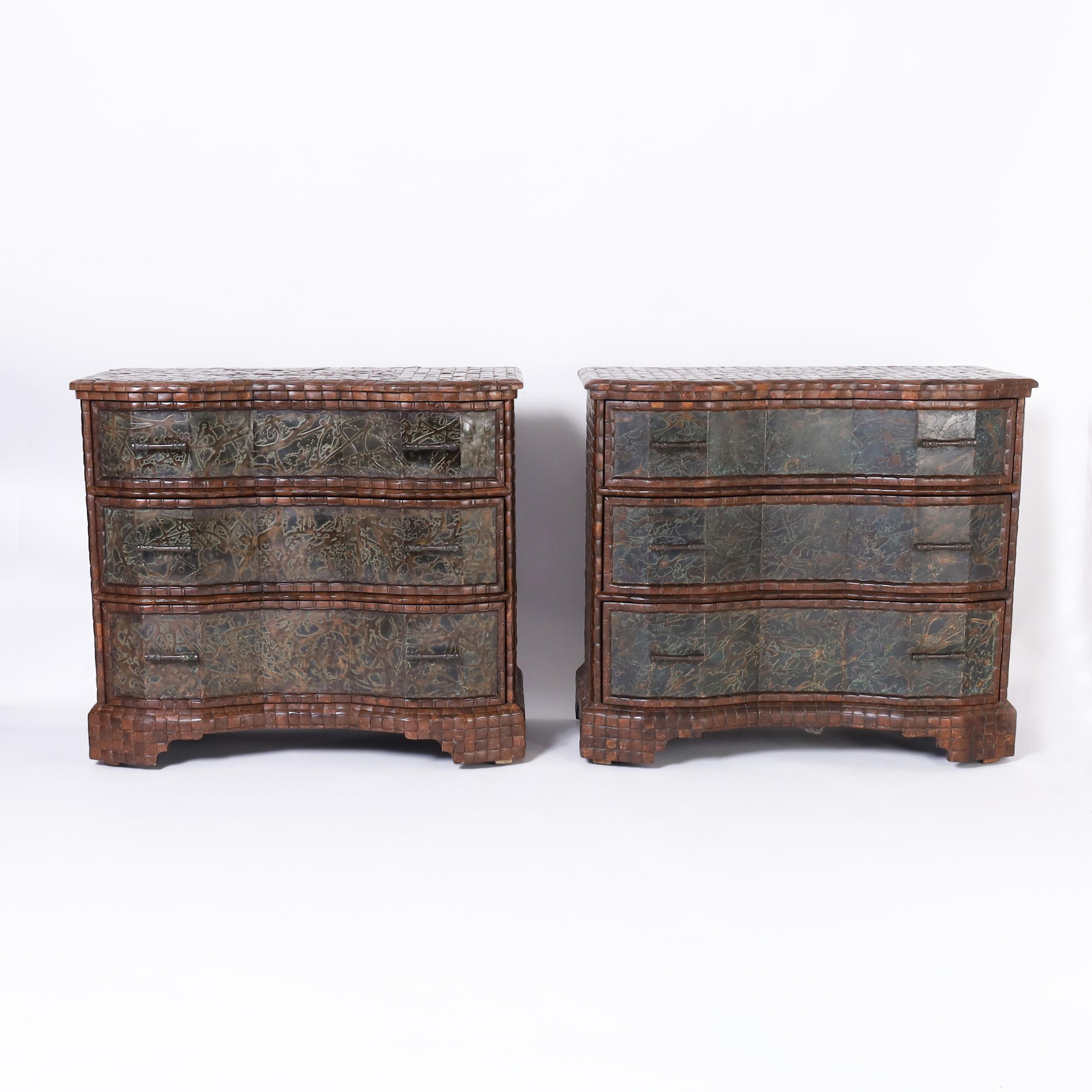 Impressive pair of mid century three drawer chest or commodes with stylized serpentine fronts handcrafted in polished coconut shell with bronze panels on the drawer fronts, bronze hardware and stylized bracket feet.