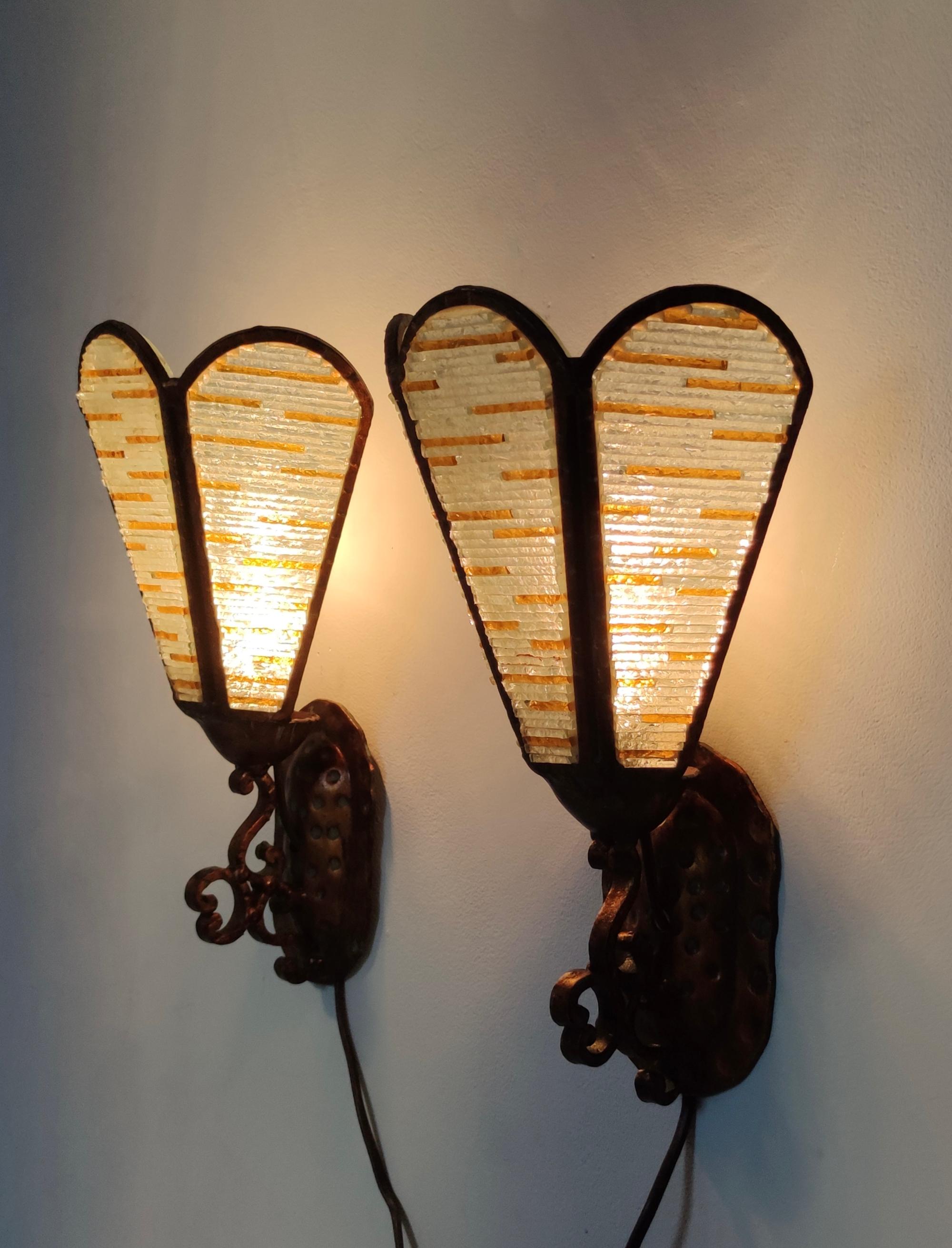 Made in Italy, 1960s. 
They are made in multi-layered Murano glass and copper. 
These are vintage wall lights, therefore they might show slight traces of use, but they can be considered as in perfect original condition and ready to give a beautiful