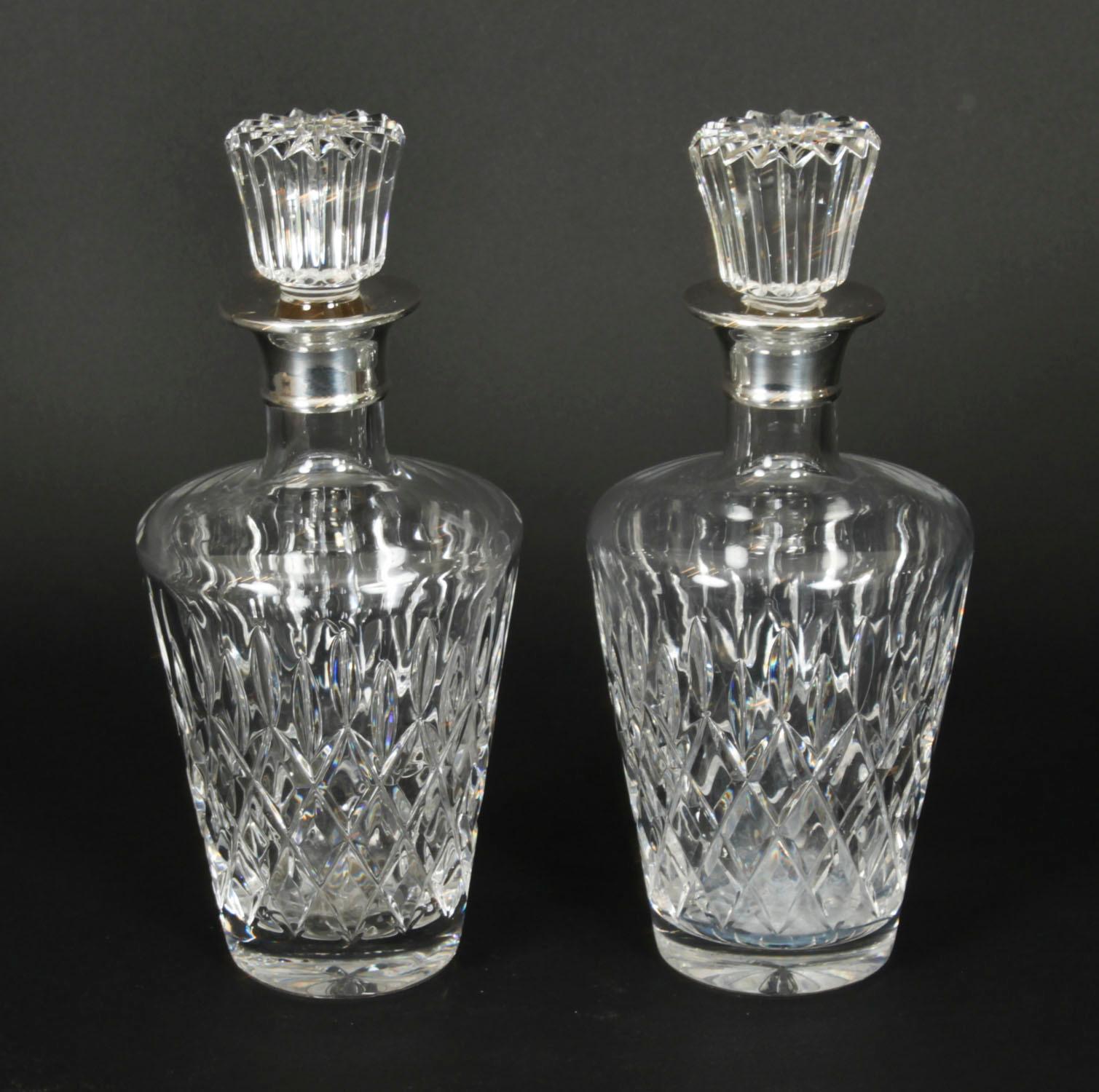 A superb pair of vintage sterling silver mounted diamond pattern crystal square decanters and stoppers, with halllmarks  for London, 1967 and the makers mark of  C J Vander Ltd

The tapering cylinder shaped diamond pattern crystal decanters feature