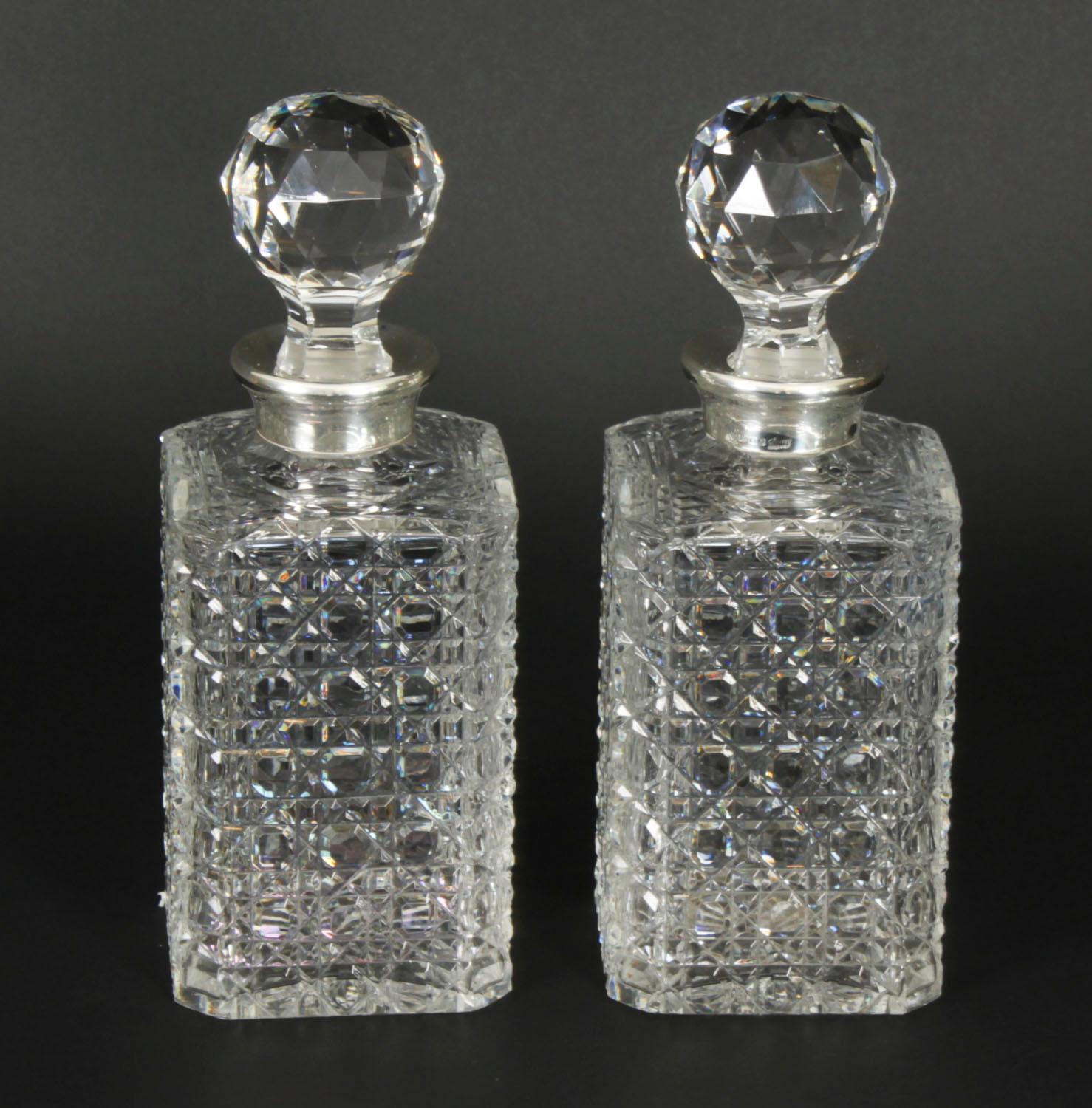 A superb pair of vintage sterling silver mounted hobnail-cut crystal square decanters and stoppers, with halllmarks  for London, 1982 and the makers mark of the world renowned Bond Street retailer Asprey & Co Ltd

The square hobnail-cut crystal