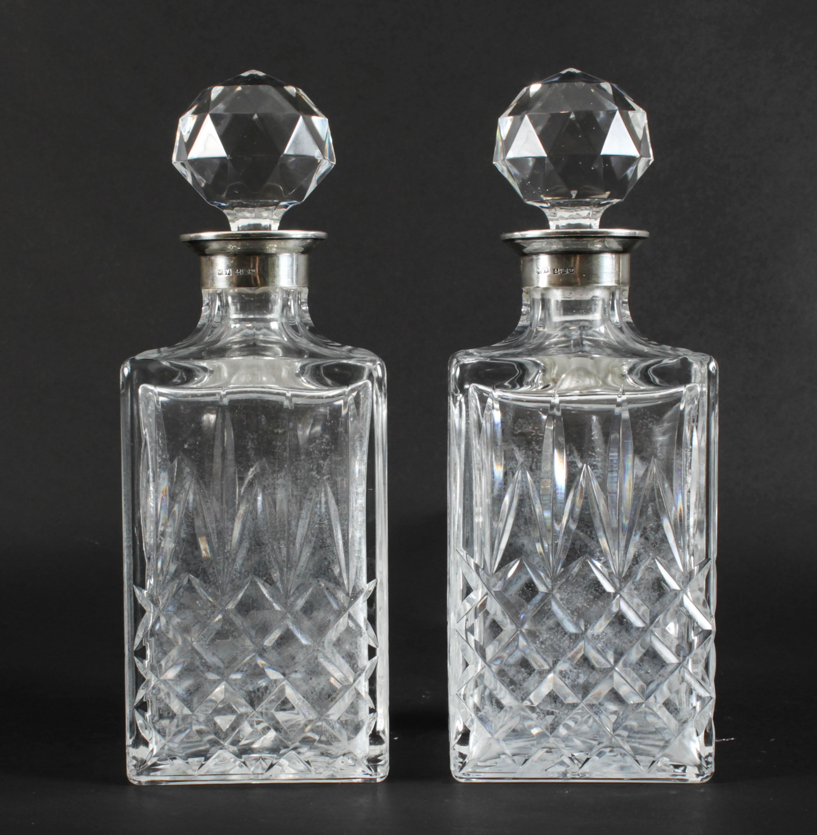A superb pair of vintage sterling silver mounted hobnail-cut crystal square decanters and stoppers, with the makers mark of Moody & Archer and hallmarks for Birmingham 1978.
Add an elegant touch to your next dining experience.
 
Condition:
In