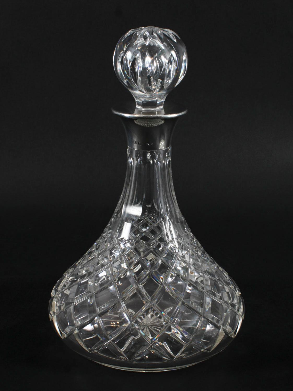 A superb pair of vintage sterling silver mounted diamond pattern crystal  ships decanters and stoppers, with halllmarks  for Birmingham, 1972 and the makers mark of Charles S Green & Co Ltd

The tapering cylinder shaped diamond pattern crystal