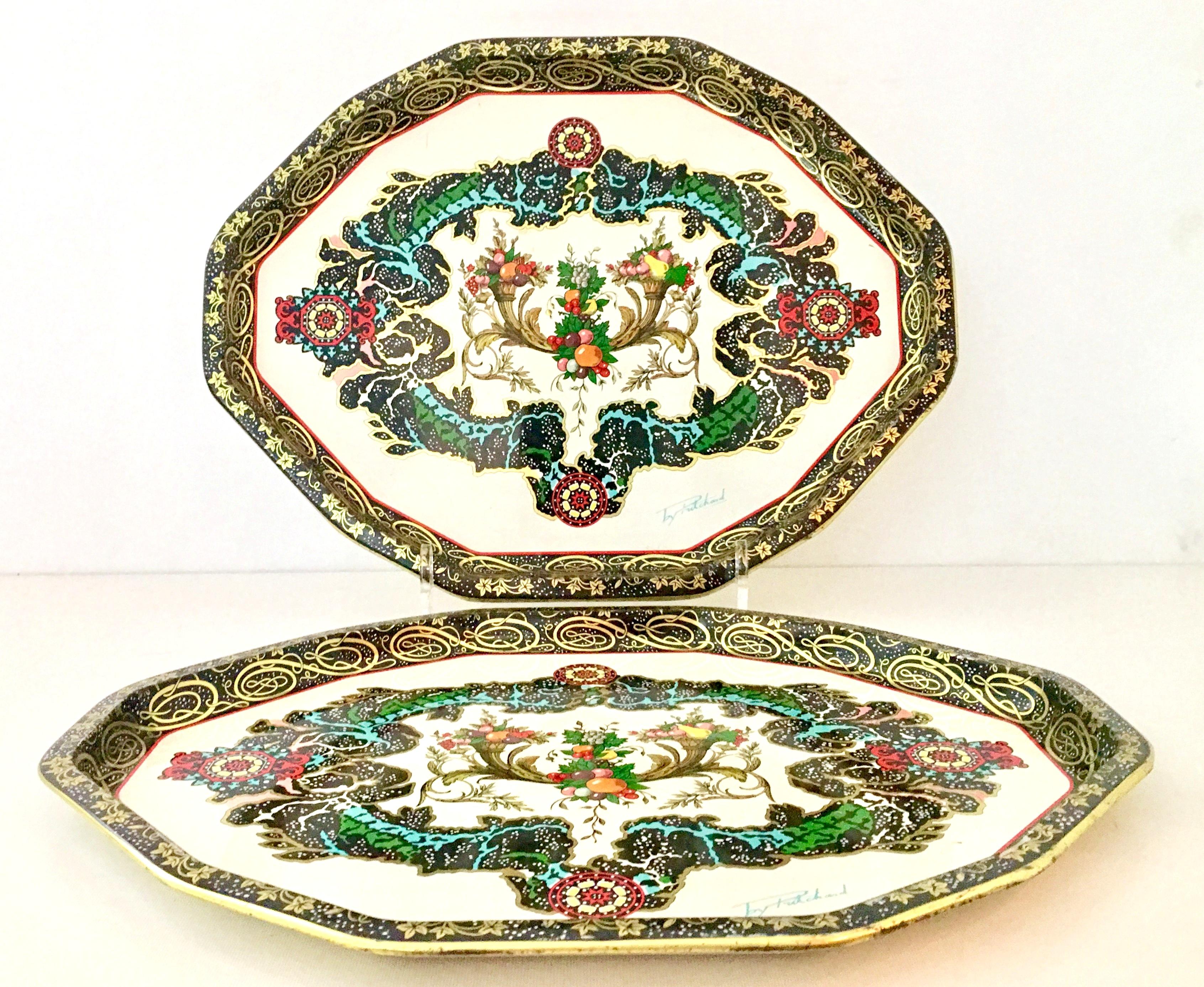 20th Century identical pair of vintage Daher England tin large serving trays designed by, Pritchard. Features a black and gold edge and rim, white ground and central paisley and fruit motif. Vibrant turquoise, green, yellow and pink finish these