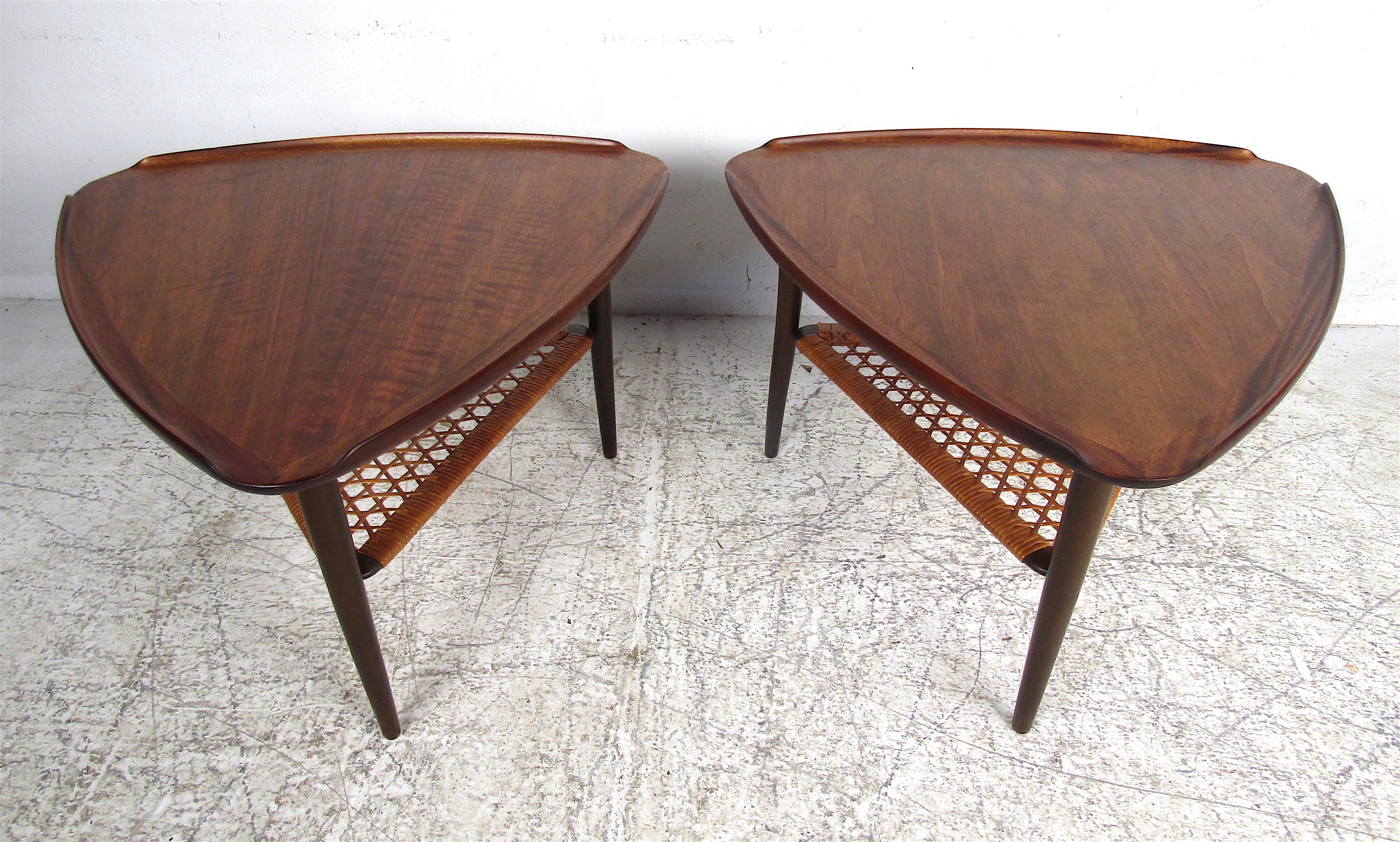 This stunning pair of Mid-Century Modern end tables boast a lovely rosewood grain throughout and a lower-tier made of woven cane. A sleek design that boasts raised edges and long tapered legs adding to the Danish modern appeal. One of a kind tripod