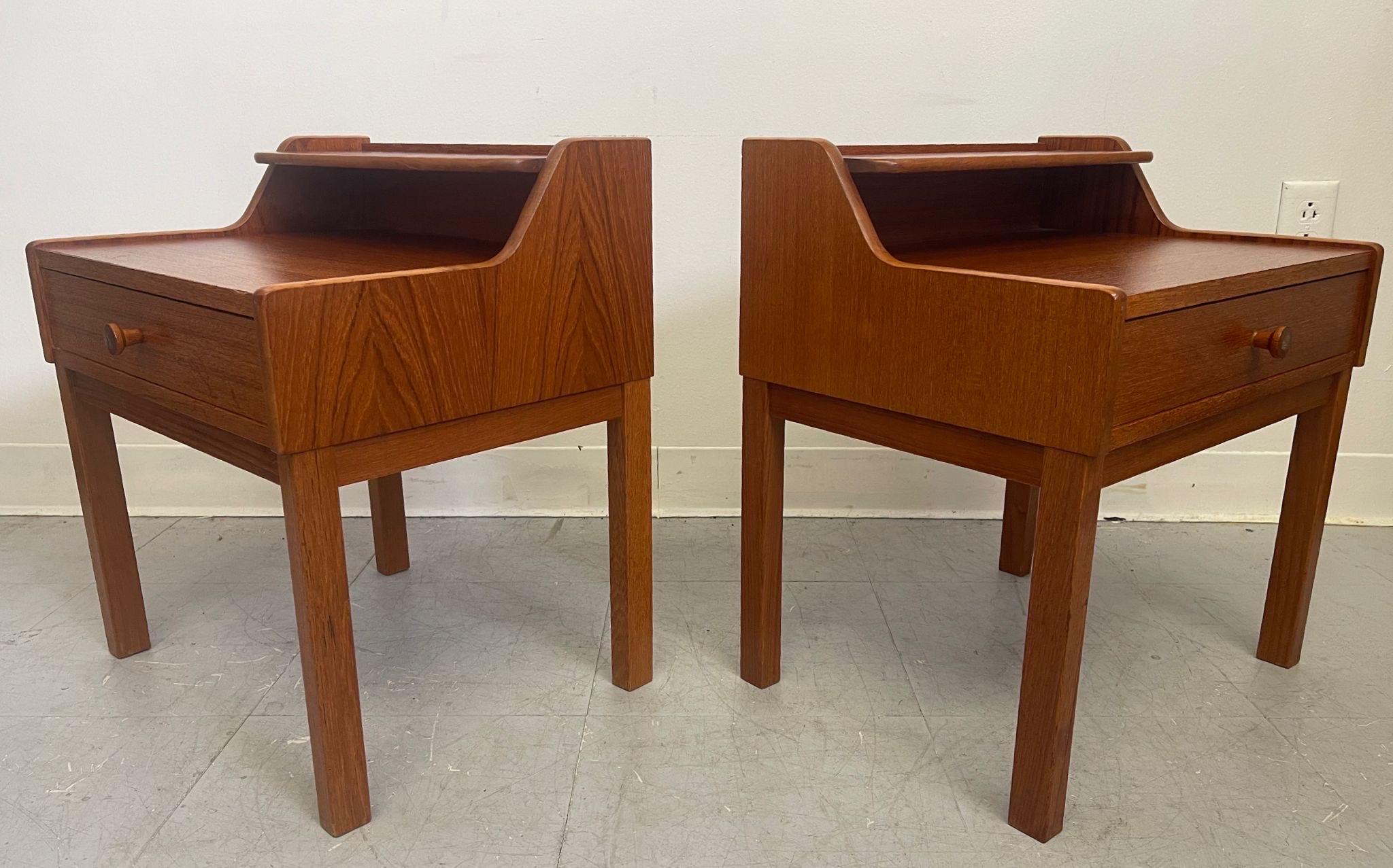 This pair of end tables features open shelf compartment above a single drawer featuring wooden handles. Circa 1970s. No Makers mark. Vintage Condition Consistent with Age as Pictured.

Dimensions. 18 W ; 13 3/4 D ; 19 1/2 H
