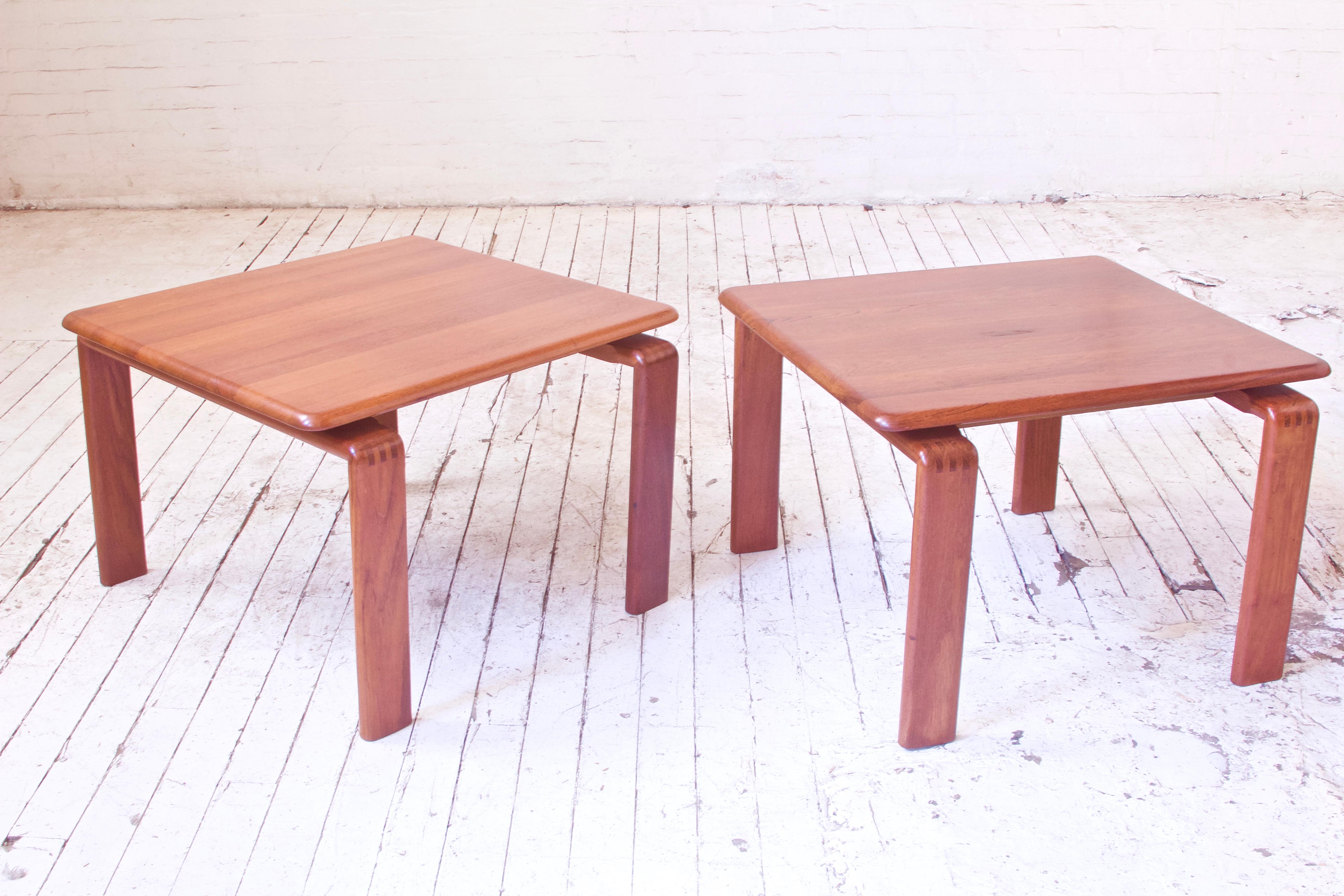 A lovely and richly-patinated pair of solid figured teak side or end tables in excellent vintage condition. Nice floating top design and rock solid exposed finger joinery make this pair stand out. Excellent sturdy construction is on display and