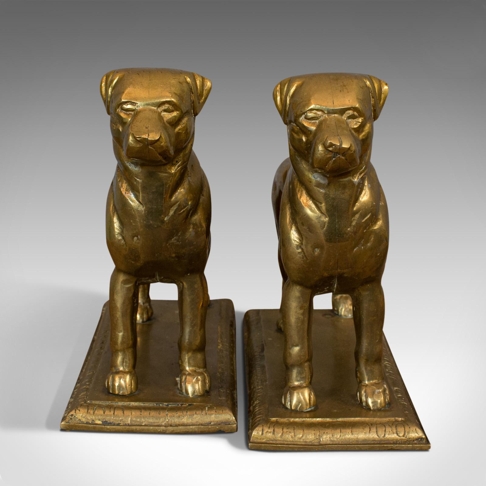 This is a vintage pair of decorative dogs. An English, cast gilt metal figure of a Rottweiler well suited as doorstops or at the fireside, dating to the mid-20th century, circa 1950.

Appealing, versatile pair of vintage dogs
Displaying a
