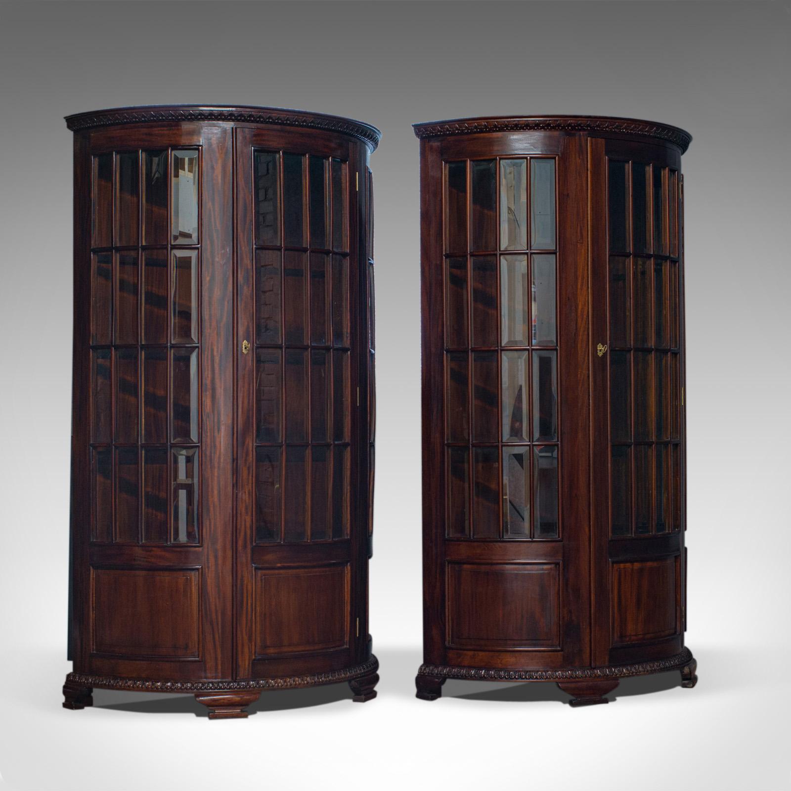 This is a vintage pair of demilune display cabinets. Two continental, mahogany, bow-fronted, glazed display cabinets dating to the late 20th century.

Impressive demilune fronted cabinets
Deep russet tones to the select mahogany
Grain interest
