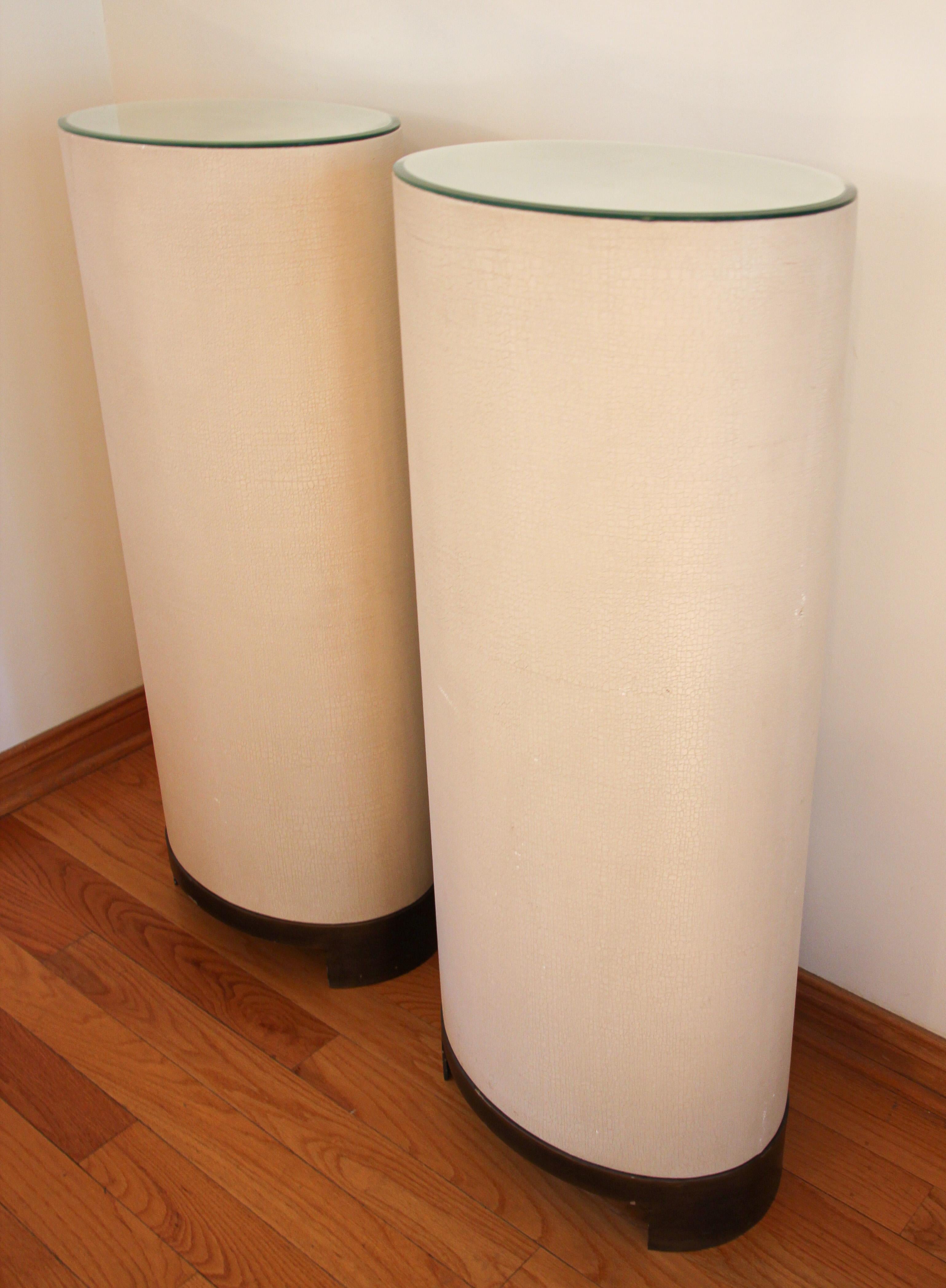 Vintage pair of ellipse pedestals by Global Views.
Global Views ellipse Antique brass stand.
The ellipse oval pedestal stands out in any interior. 
Each piece is first hand-wrapped on all sides in Belgian linen over an acacia veneer. A complex