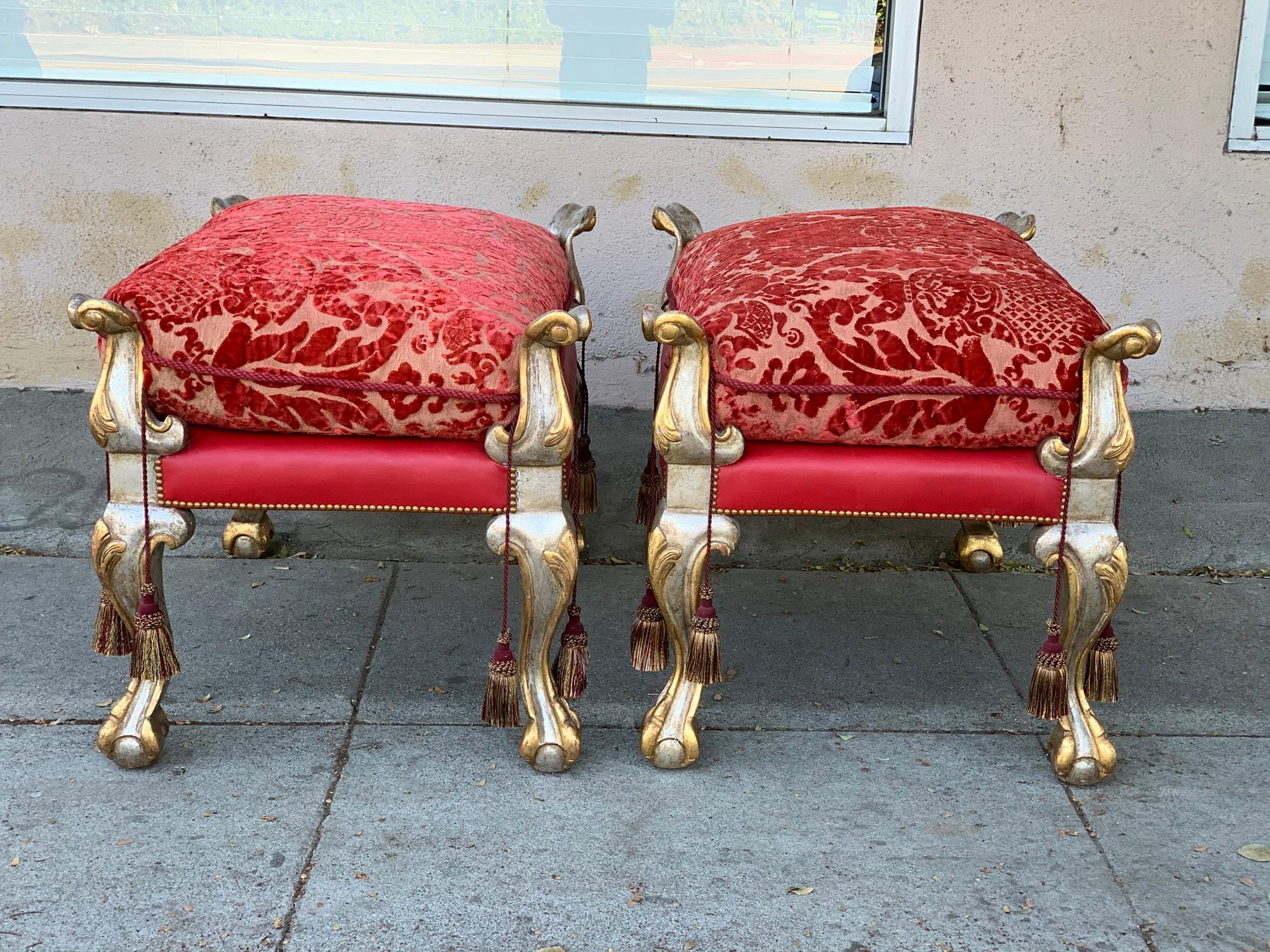 Beautiful pair of vintage Empire style benches with a gold and silver gilded frames, carved paws and eagle like carved finials, upholstered in a vintage silk material.
The benches are in very good vintage condition with minor wear to fabric and