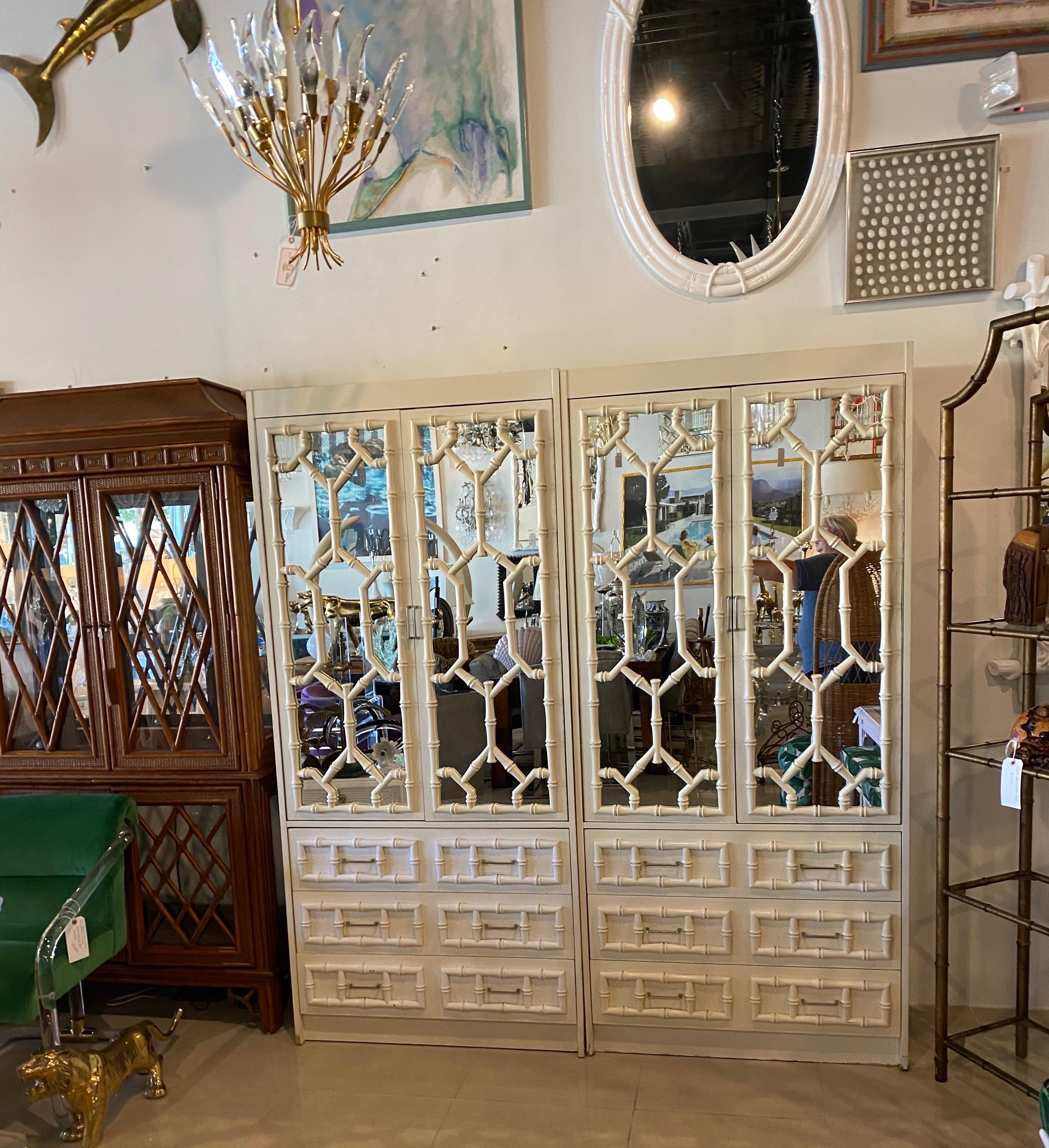 Vintage pair of faux bamboo, Chinese Chippendale, mirrored cabinets. There are 2 adjustable shelves, 1 stationary and the bottom shelf. The bottom is 3 drawers. These have their original finish with scuffs and wear. These will need to be lacquered