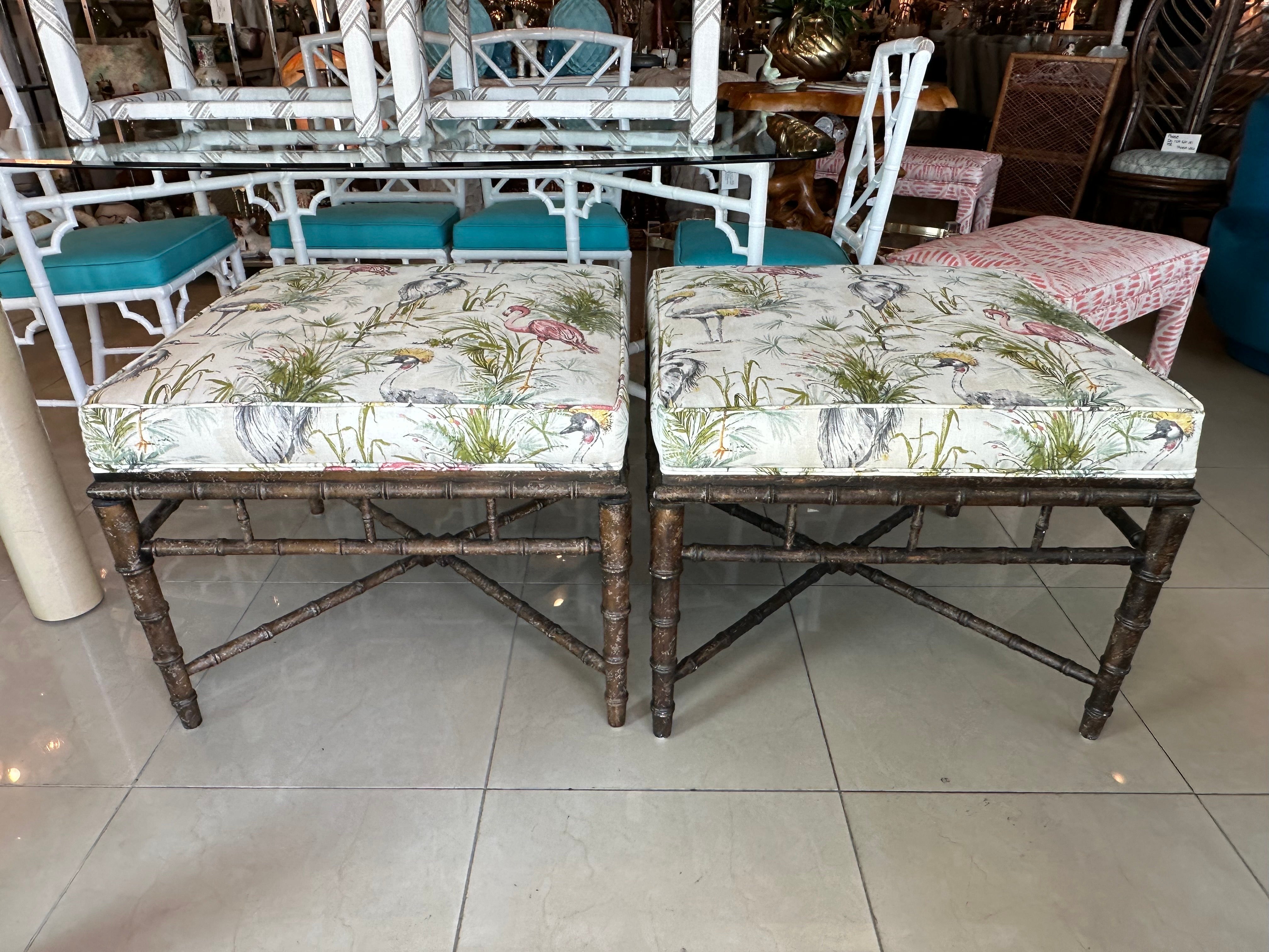 Lovely pair of vintage faux bamboo ottomans, benches, stools. Newly upholstered in a bird fabric. Original wood finish. No damage or defects. Dimensions: 21.5 H x 27.5 W x 27.5 D.