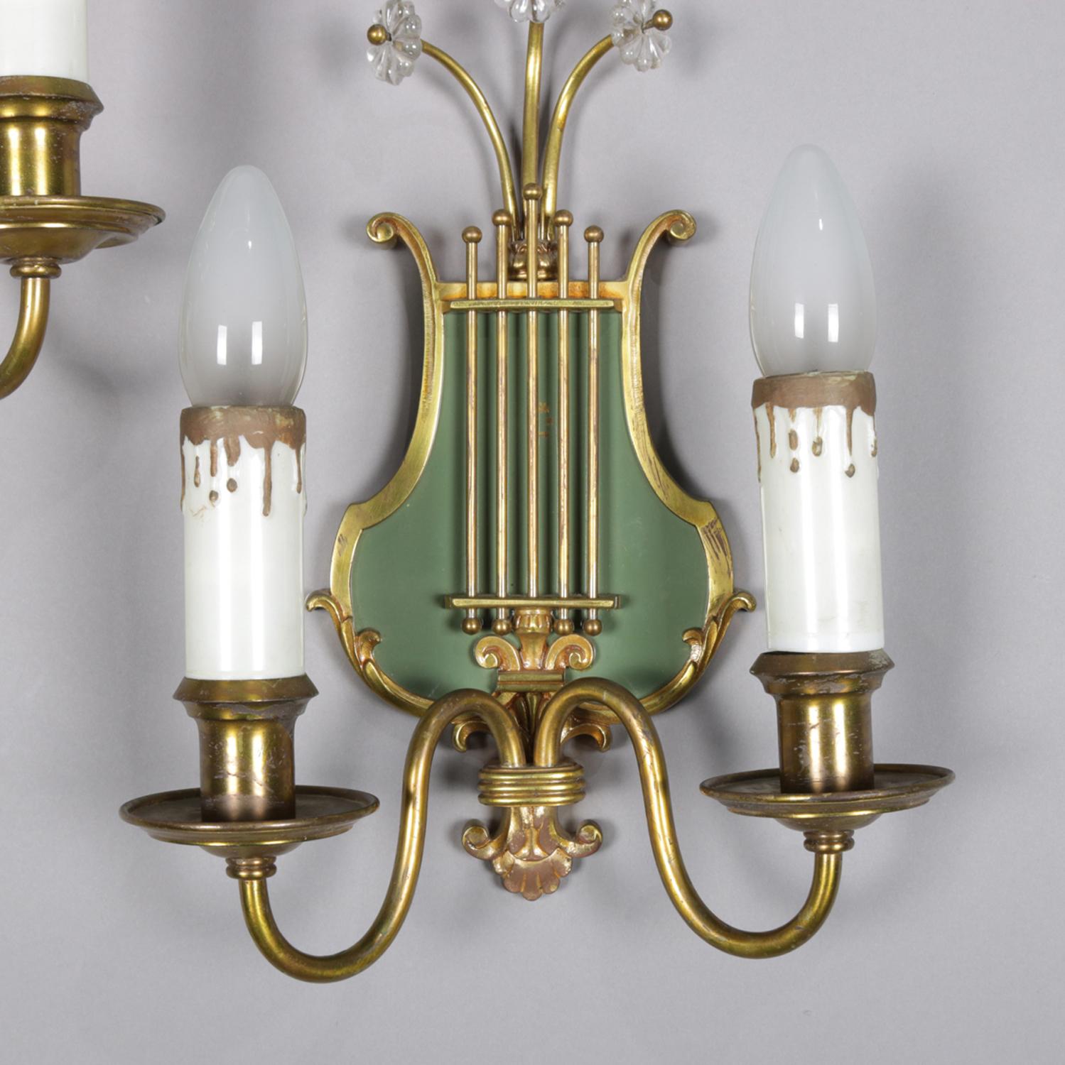 A vintage pair of Federal style electric wall sconces feature brass lyre form frames each with two candle lights having gilt drips, crests with crystal floral elements, professionally rewired, 20th century

Measures: 12