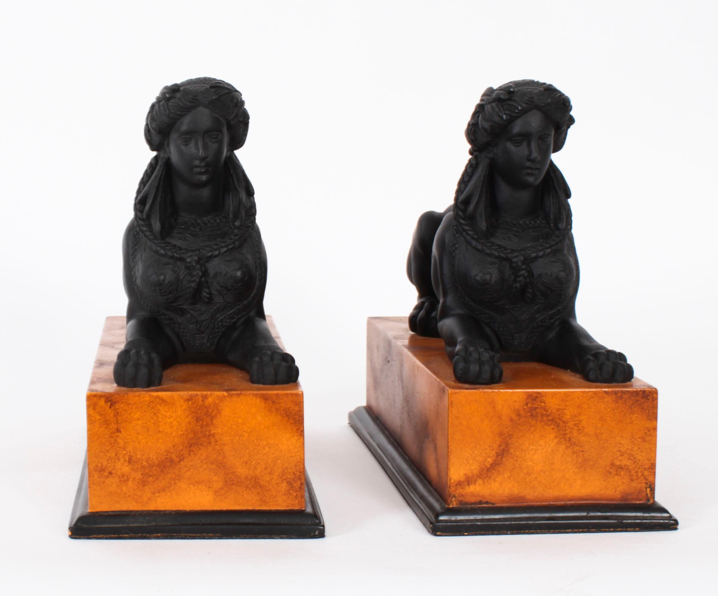 This is a beautiful Vintage pair of French composite sculptures of Egyptian recumbent Sphinx, dating from the late 20th Century.

Each  sphinx is modelled wearing a pharaonic headdress on a human head with a lions body.

Both statues have a lovely