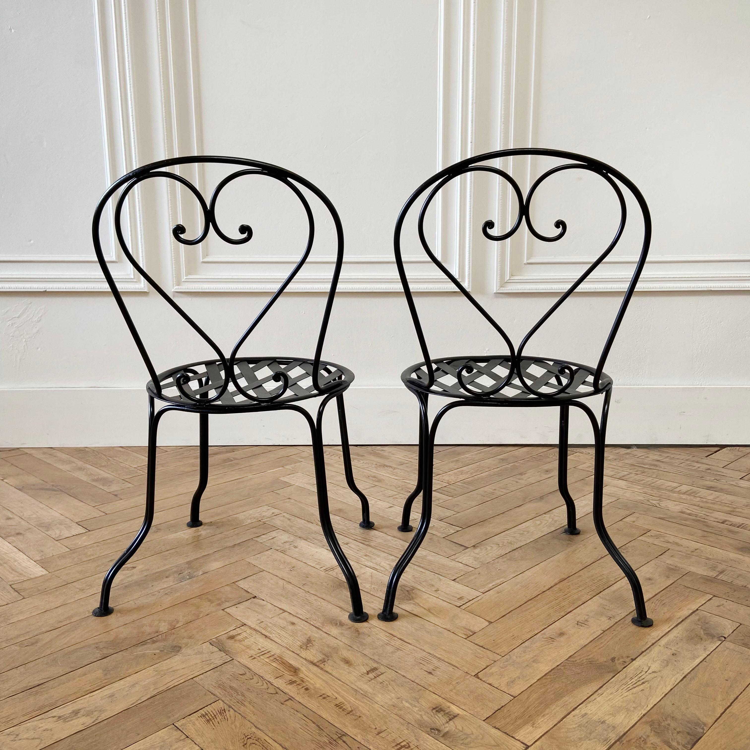 Vintage pair of French style black iron bistro chairs

Measures: 19” W x 19” D x 30.5” H
Seat height: 16”
Seat depth: 15”.