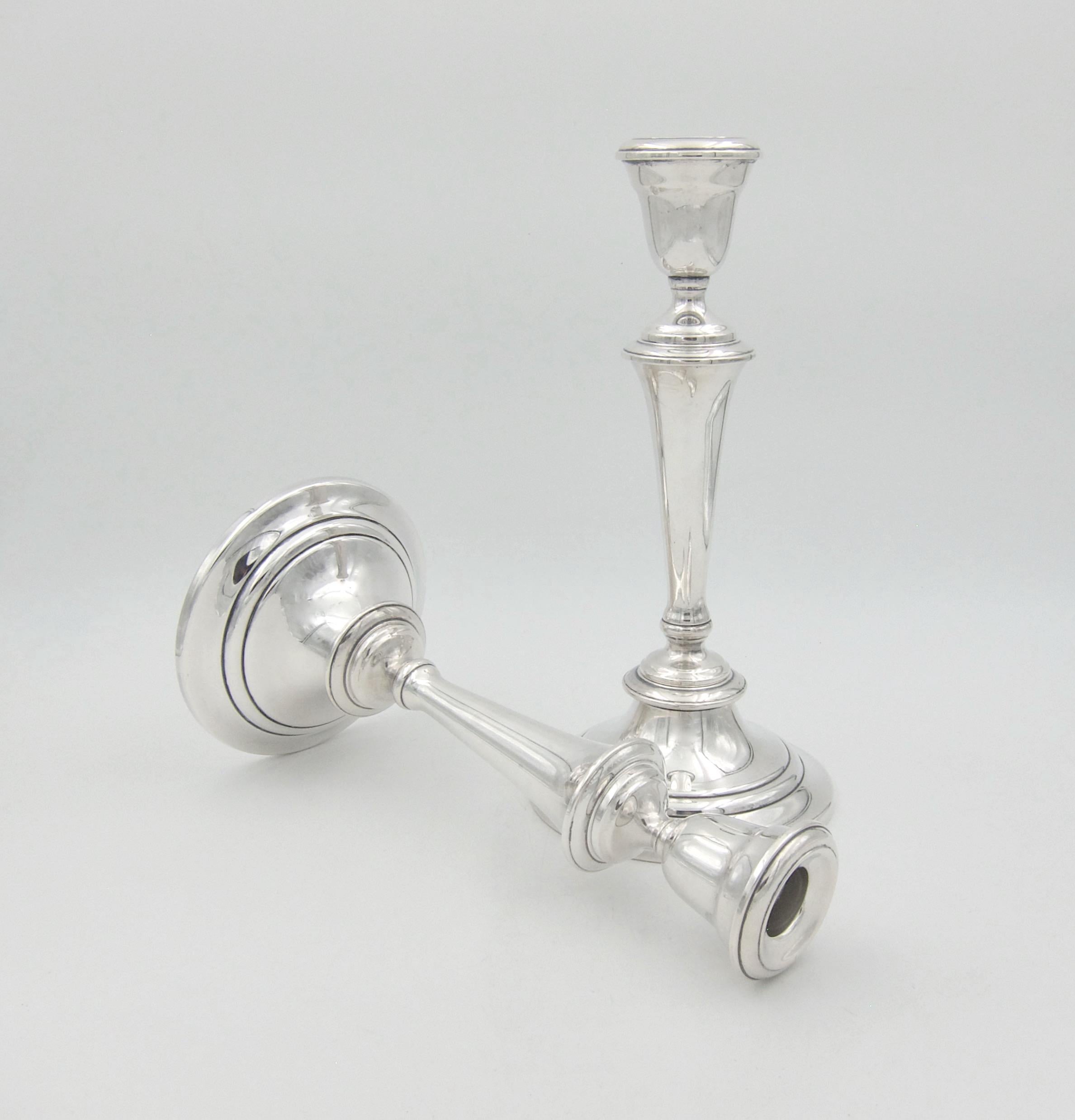 A vintage convertible candlestick pair from Gorham Manufacturing Company of Providence, Rhode Island. The silver plated candle holders are each composed of three parts: a weighted circular base supporting a tapering stem with an urn on top. The
