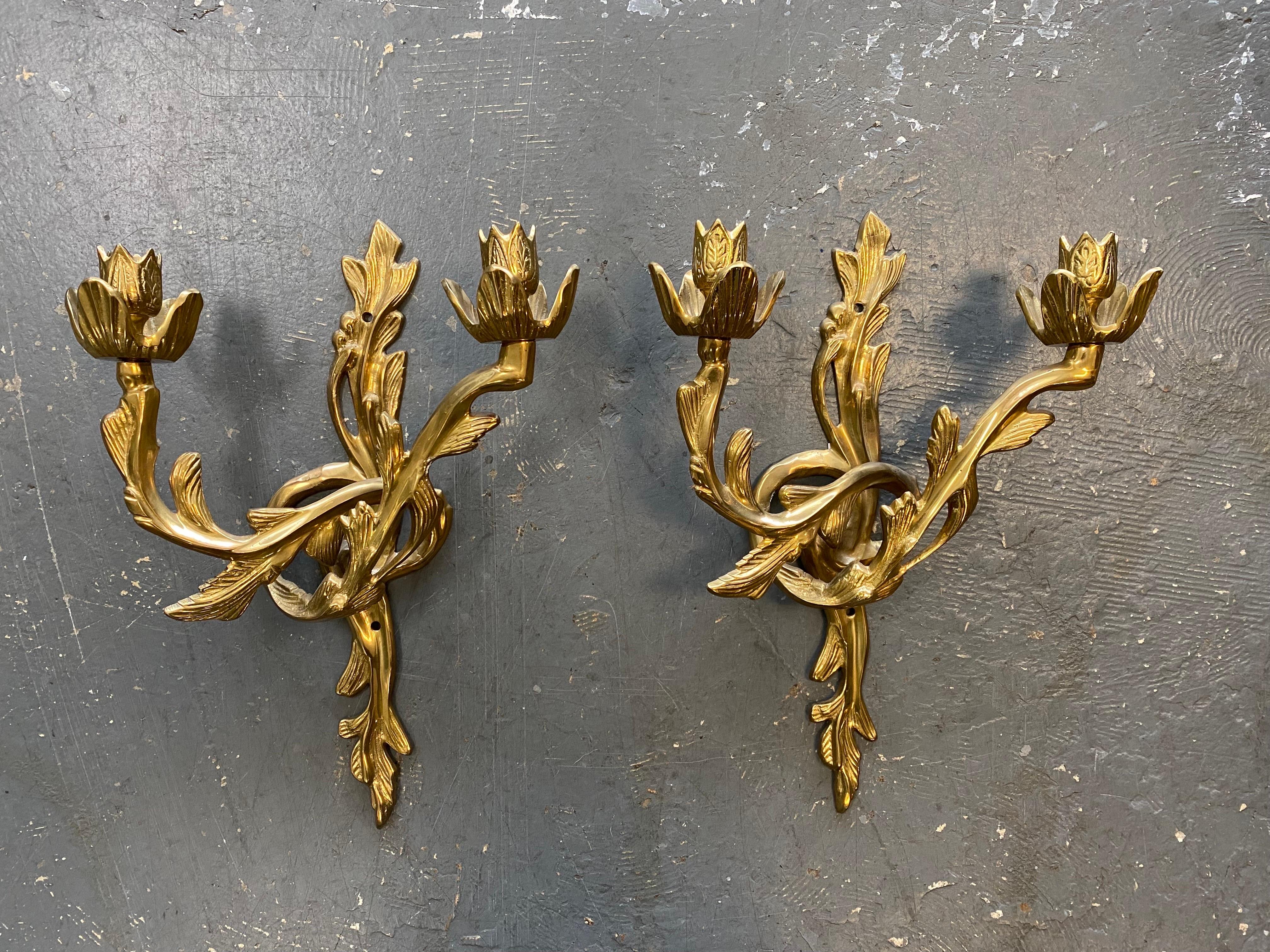 Beautiful pair of Hollywood regency solid brass wall sconce candleholders. The pair, with 2 candleholders each, is in excellent condition with barely any signs of wear.

Designer Rochelle Greayer once said of Hollywood Regency: 