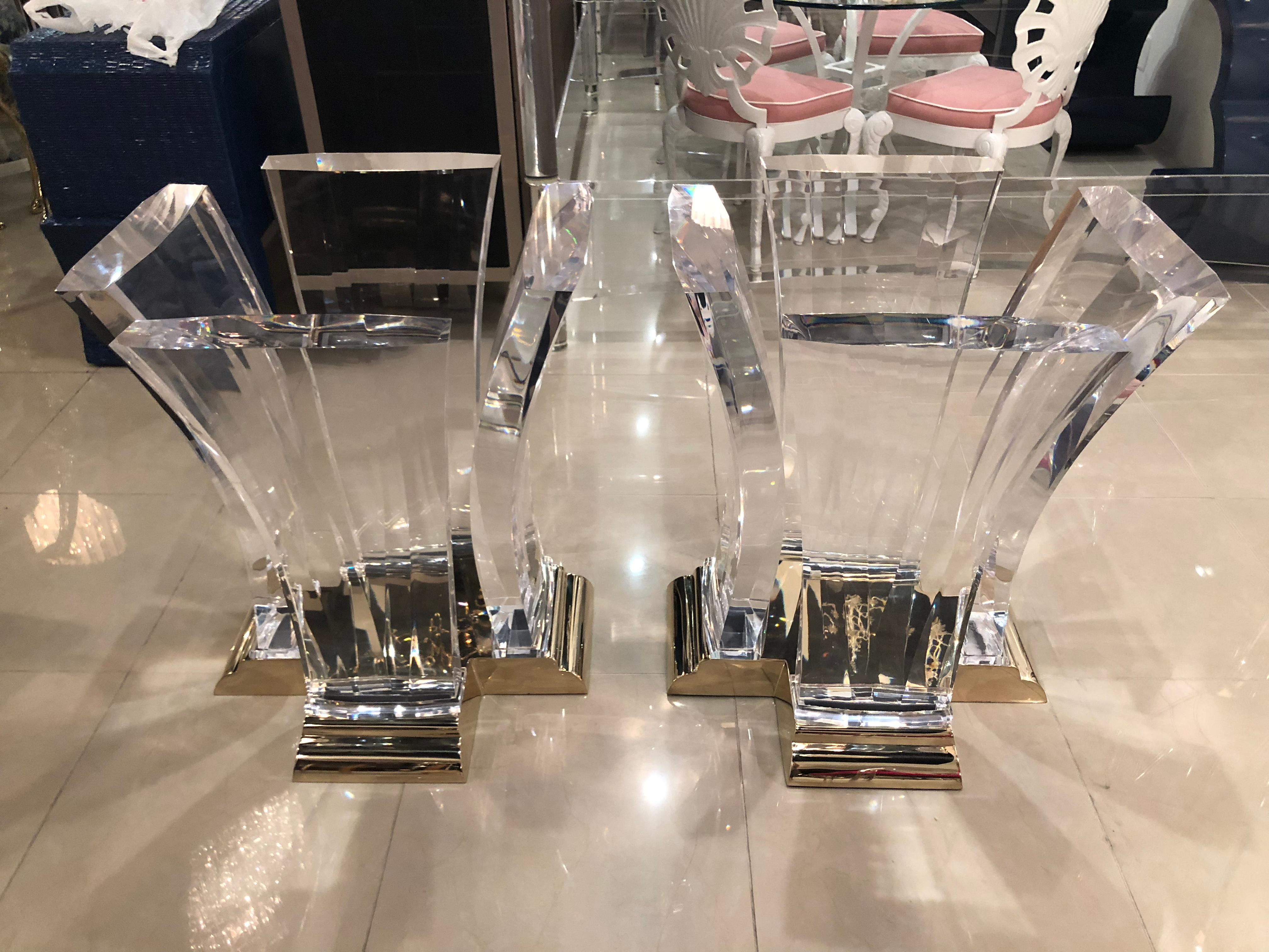 Vintage pair of Jeffrey Bigelow Lucite dining table bases with brass, bronze base. Lucite has been professionally polished. Brass has been professionally polished. One small knock on bottom of Lucite, by base. Pictured but barely visible. These can