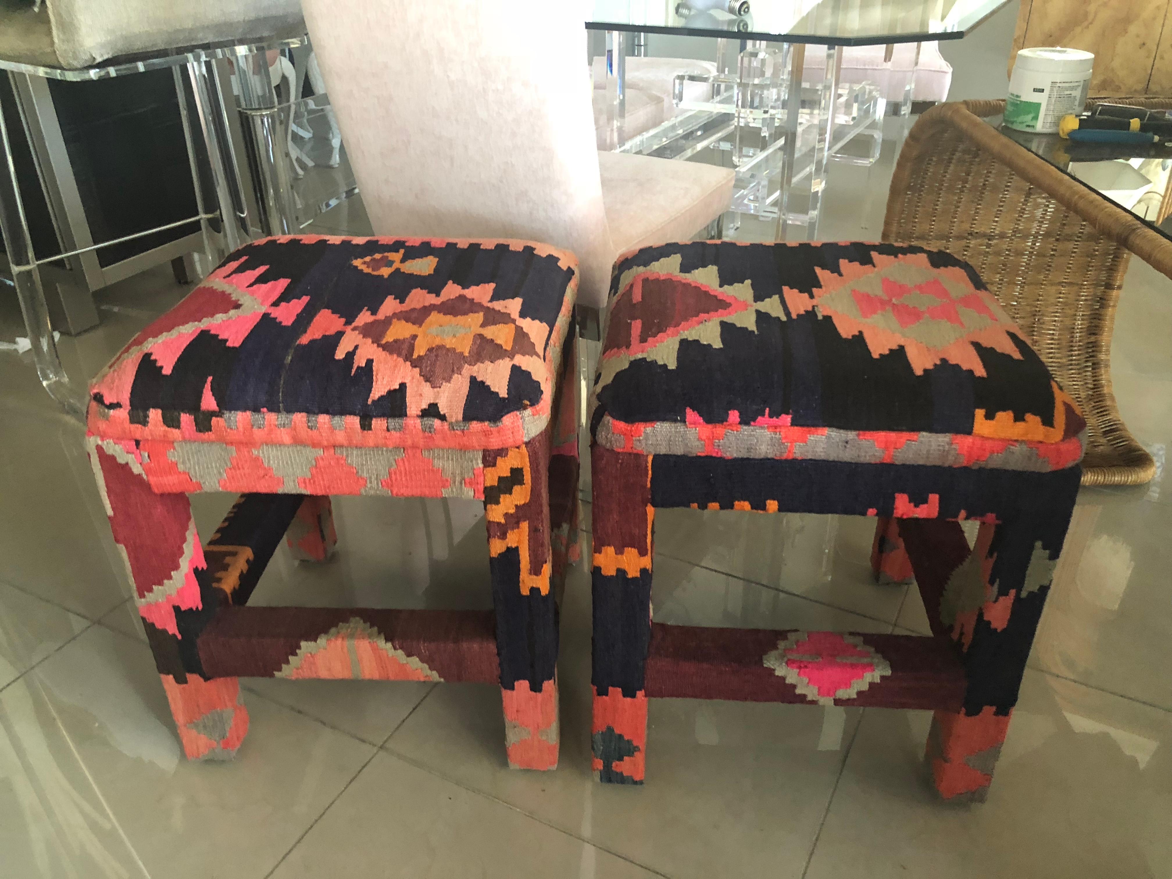 Vintage pair of Kilim rug ottomans, benches, stools. There may be slight color variations on these as they are done in a vintage Kilim. The colors are beautiful as well as the texture.
    