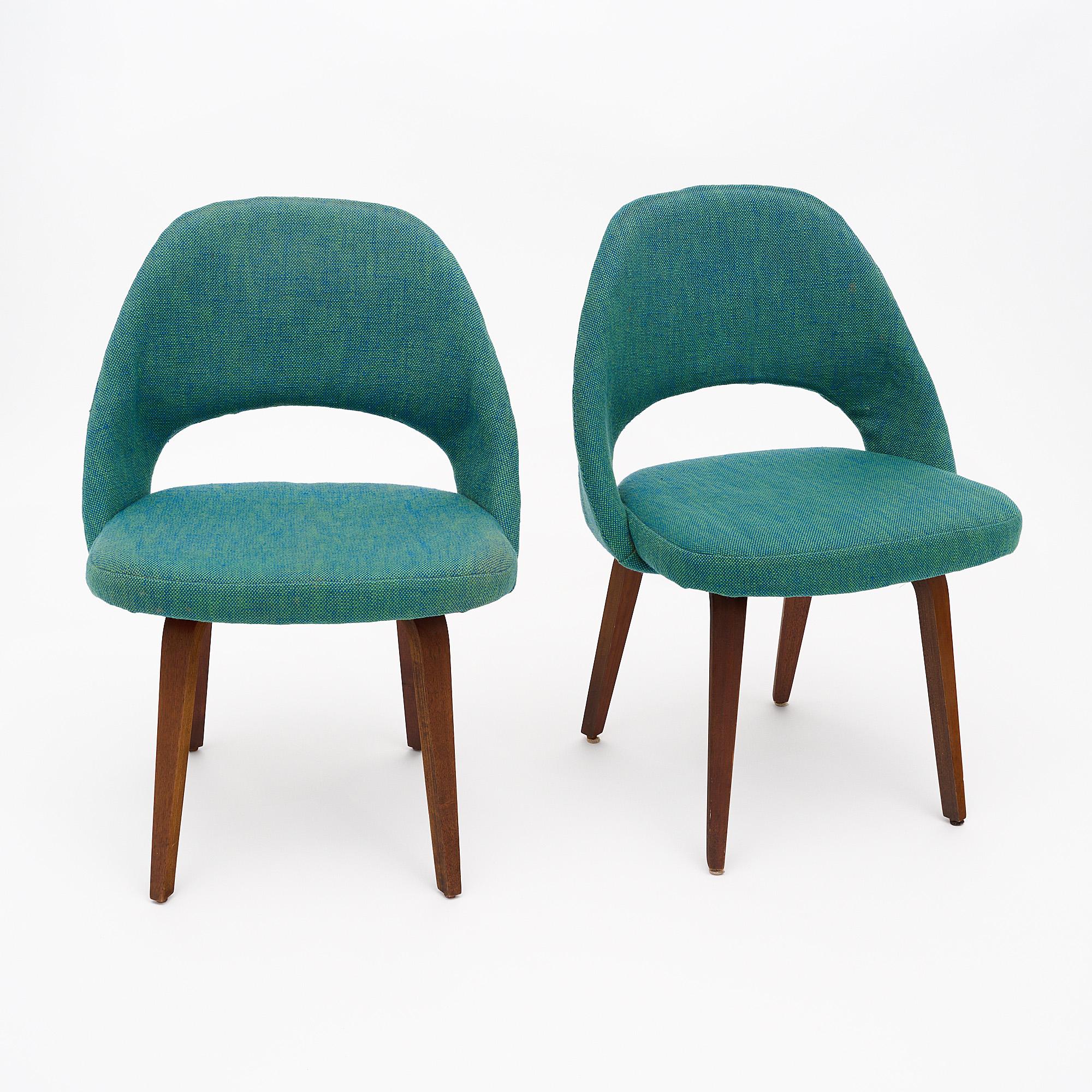 Pair of chairs by Knoll with original green and blue woven fabric in good condition. Originally featured in almost all of the Florence Knoll’s interiors, the Sarrinen Executive chair has remained a popular design. The legs are walnut. Once chair