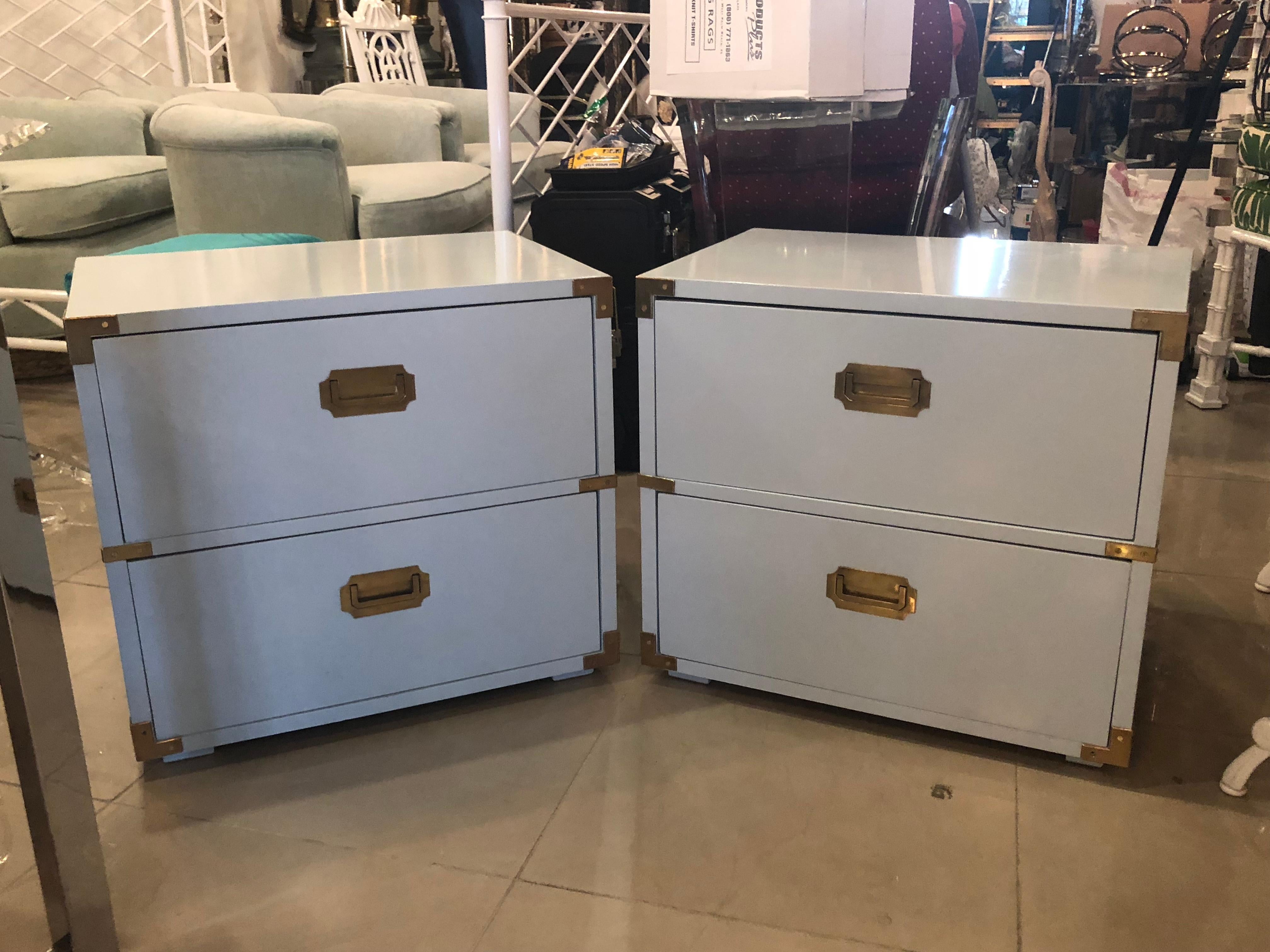 Lovely vintage pair of Lane Furniture campaign nightstands. These have been professionally lacquered in a powder blue. Brass hardware has been polished. May be minor imperfections to the newly lacquered finish.
 