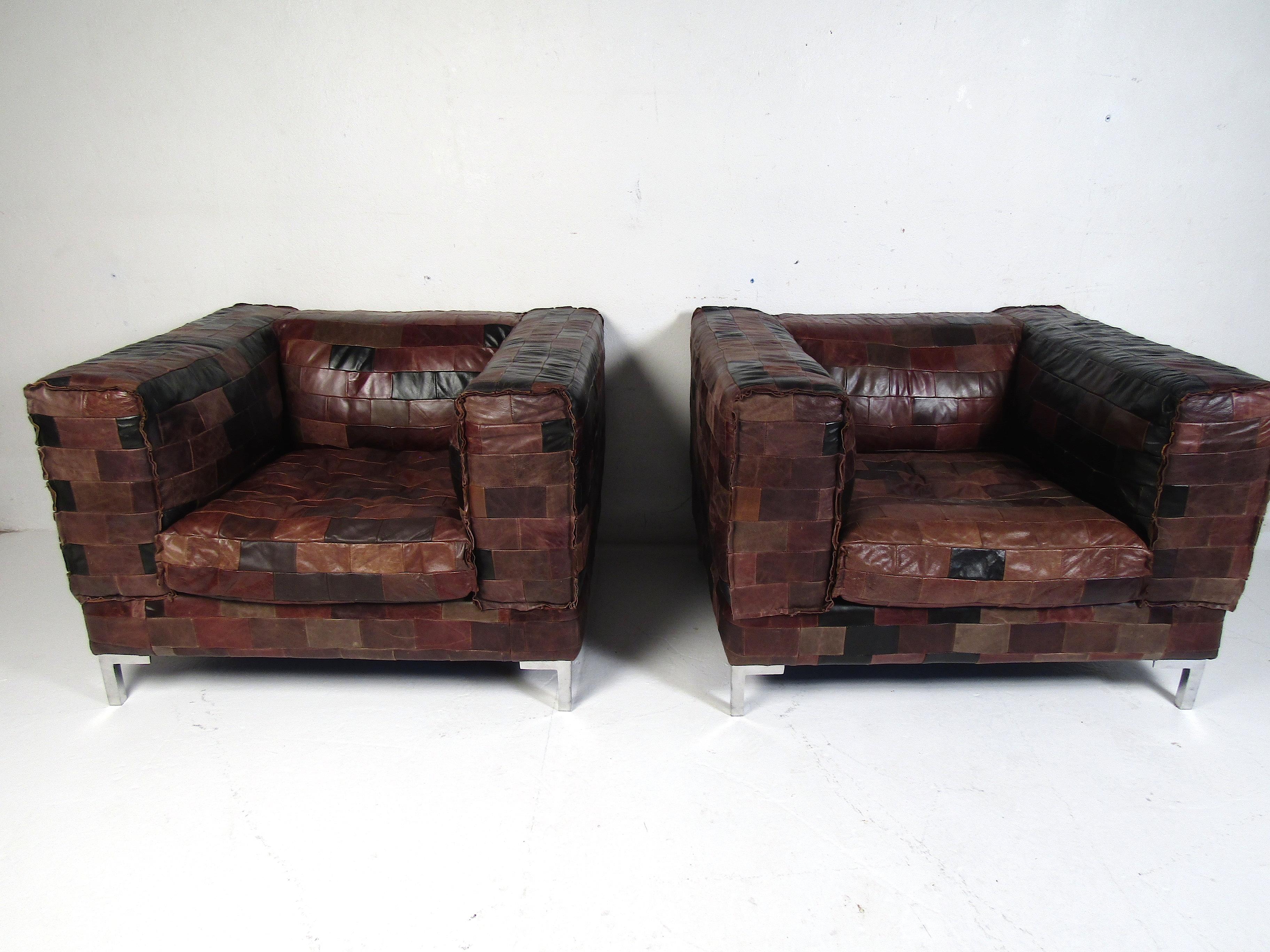 Very unusual and stylish pair of club chairs with a leather-patchwork upholstery. Spacious and comfortable chairs, supported by chrome-plated leg supports. Reminiscent of Paul Evans' designs. Please confirm item location with dealer (NJ or NY).