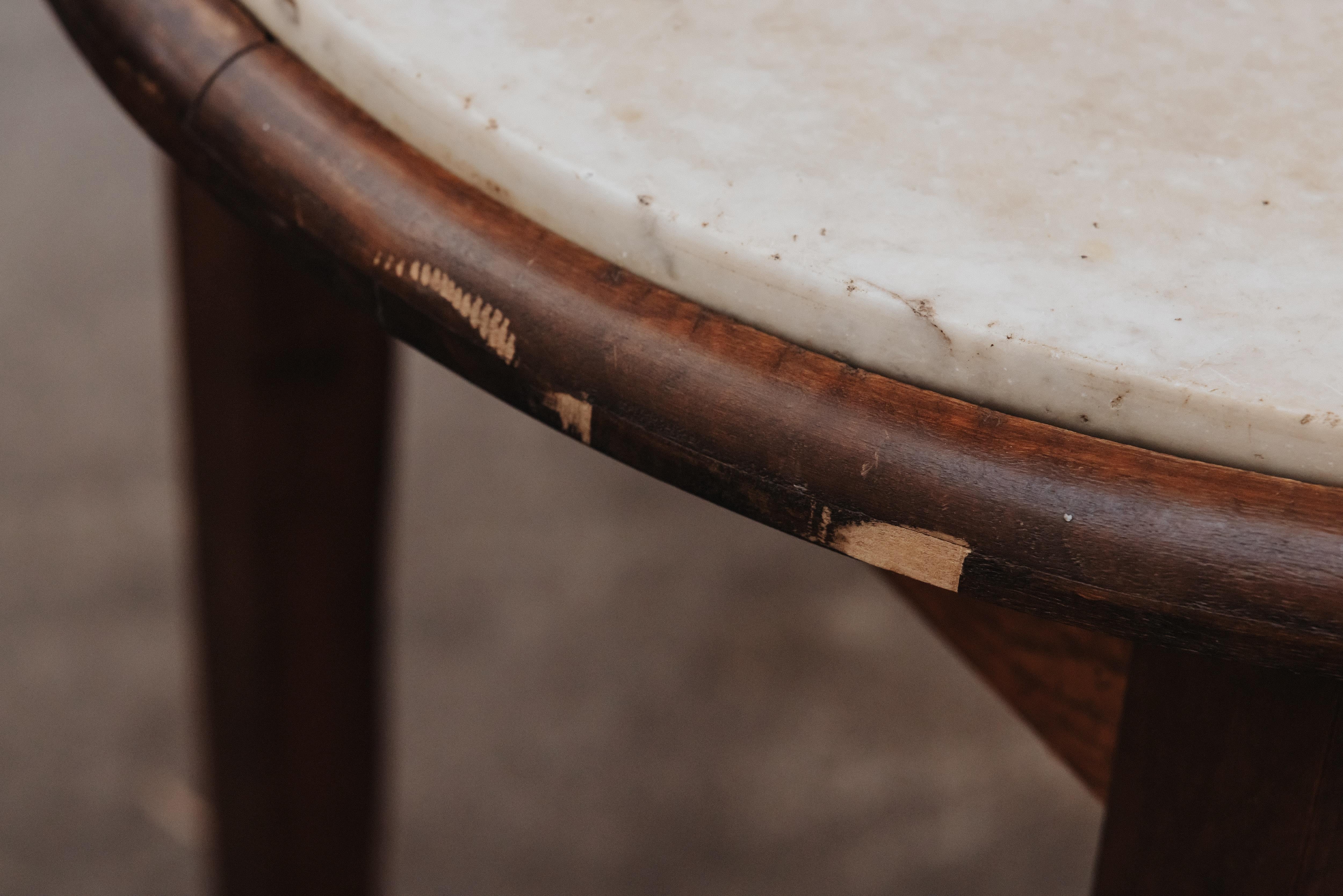 Vintage Pair Of Marble Bistro Tables From France, Circa 1960.  Solid marble top on a wood base.  Nice patina and use.
