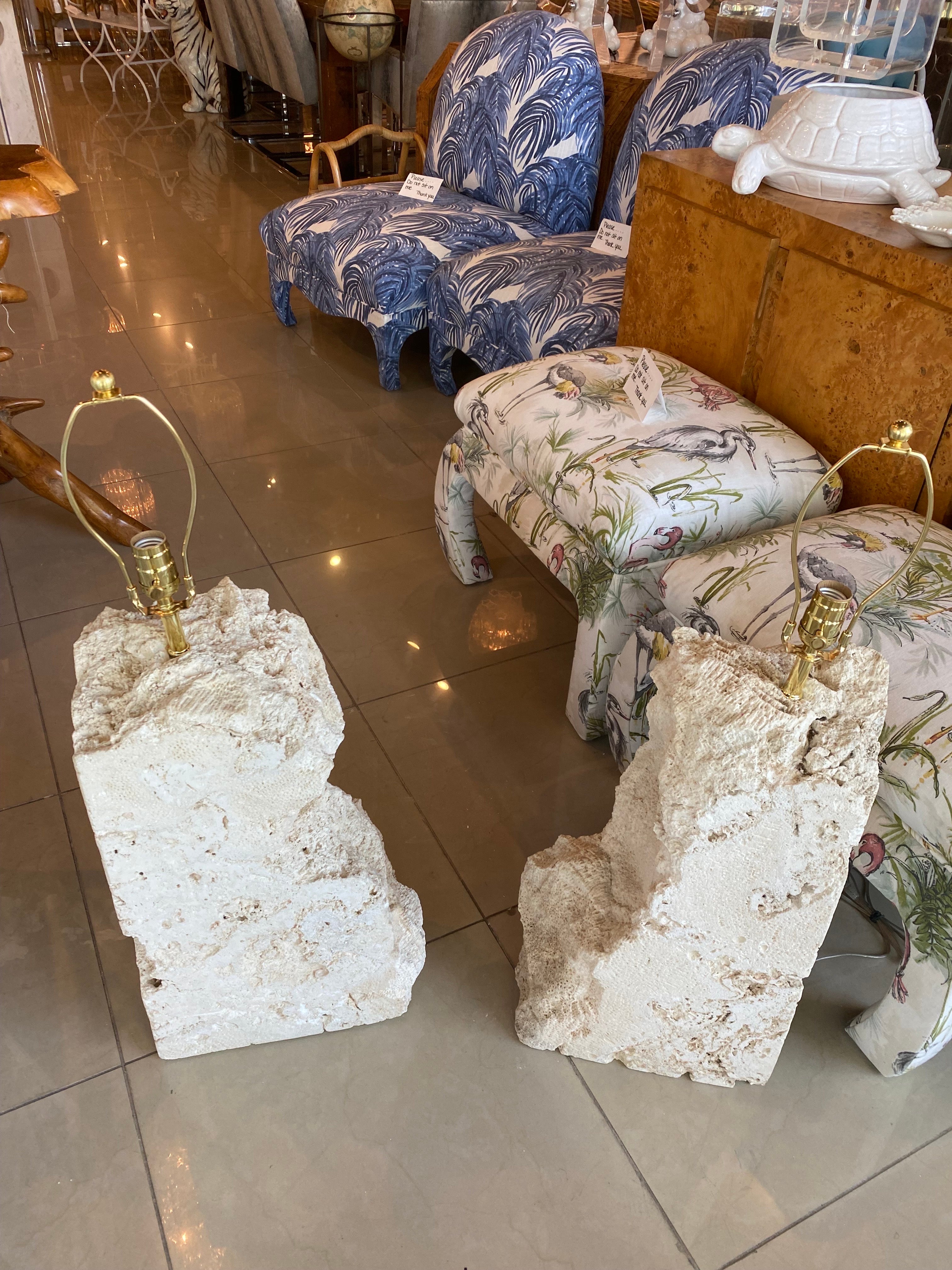 Massive pair of vintage coquina stone table lamps. These have been professionally wired with all new brass hardware and 3 way sockets. These weigh approx 70 pounds each. dimensions: 33.5 H (to top of finial) x 27 H (to top of socket) x 13.5 W x 6.5