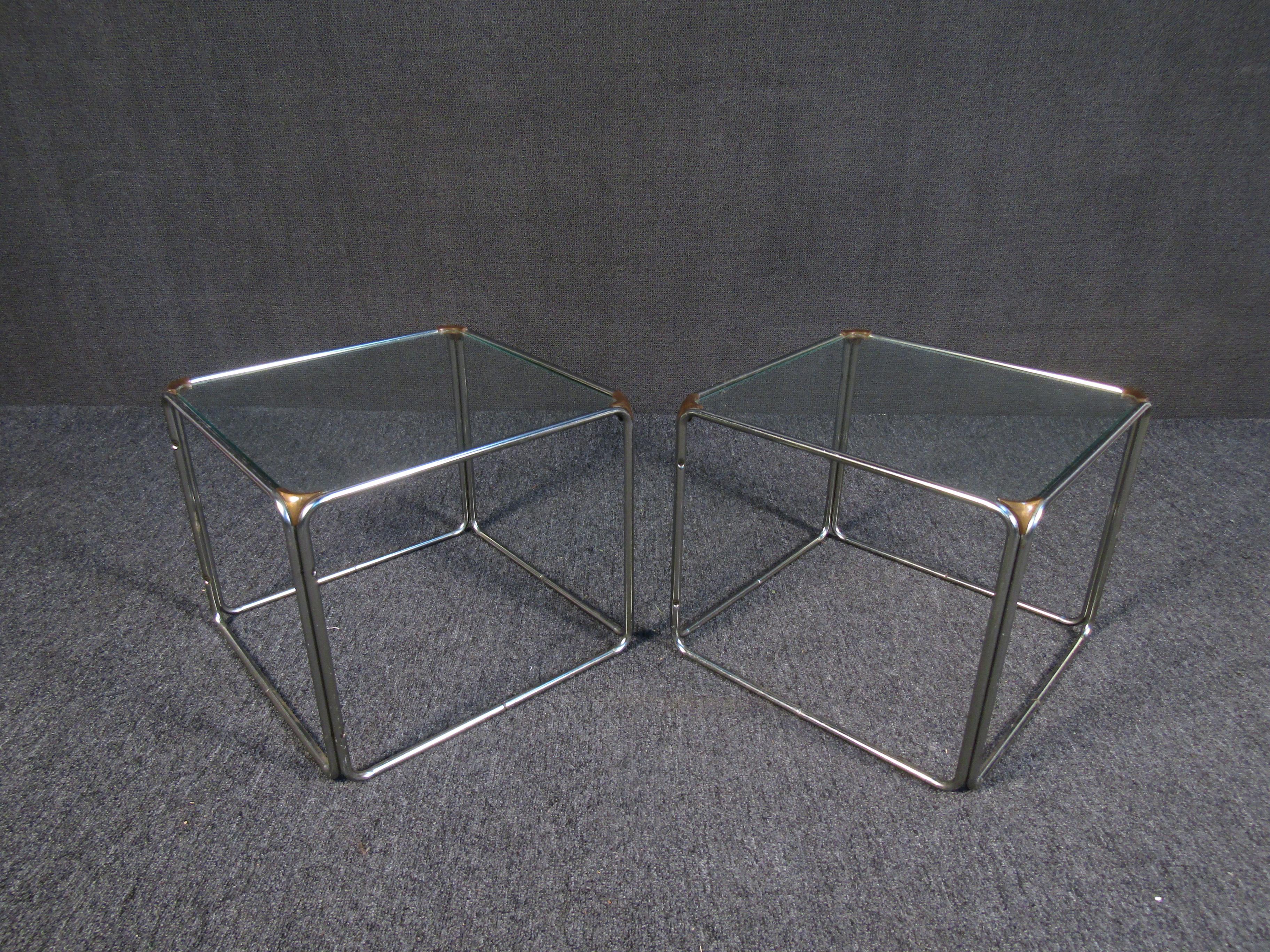Minimal and elegant, this vintage pair of side tables combines metal frames with a square glass top. Please confirm item location with seller (NY/NJ).