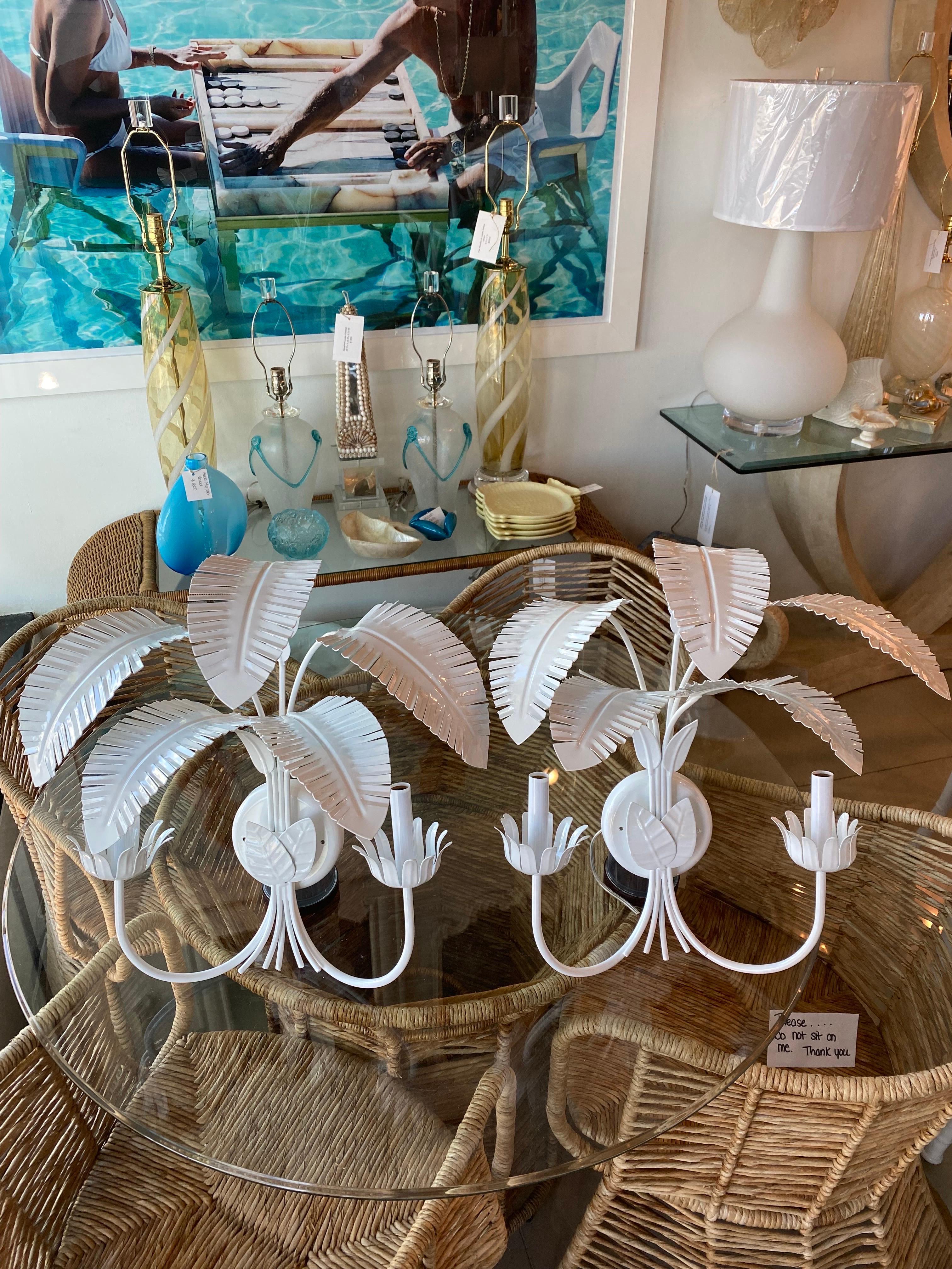 Amazing pair of vintage metal palm tree leaf wall light sconces. These have been newly wired, new light sockets and Powder-coated a fresh white. Dimensions: 19 H x 19 W x 11 D.