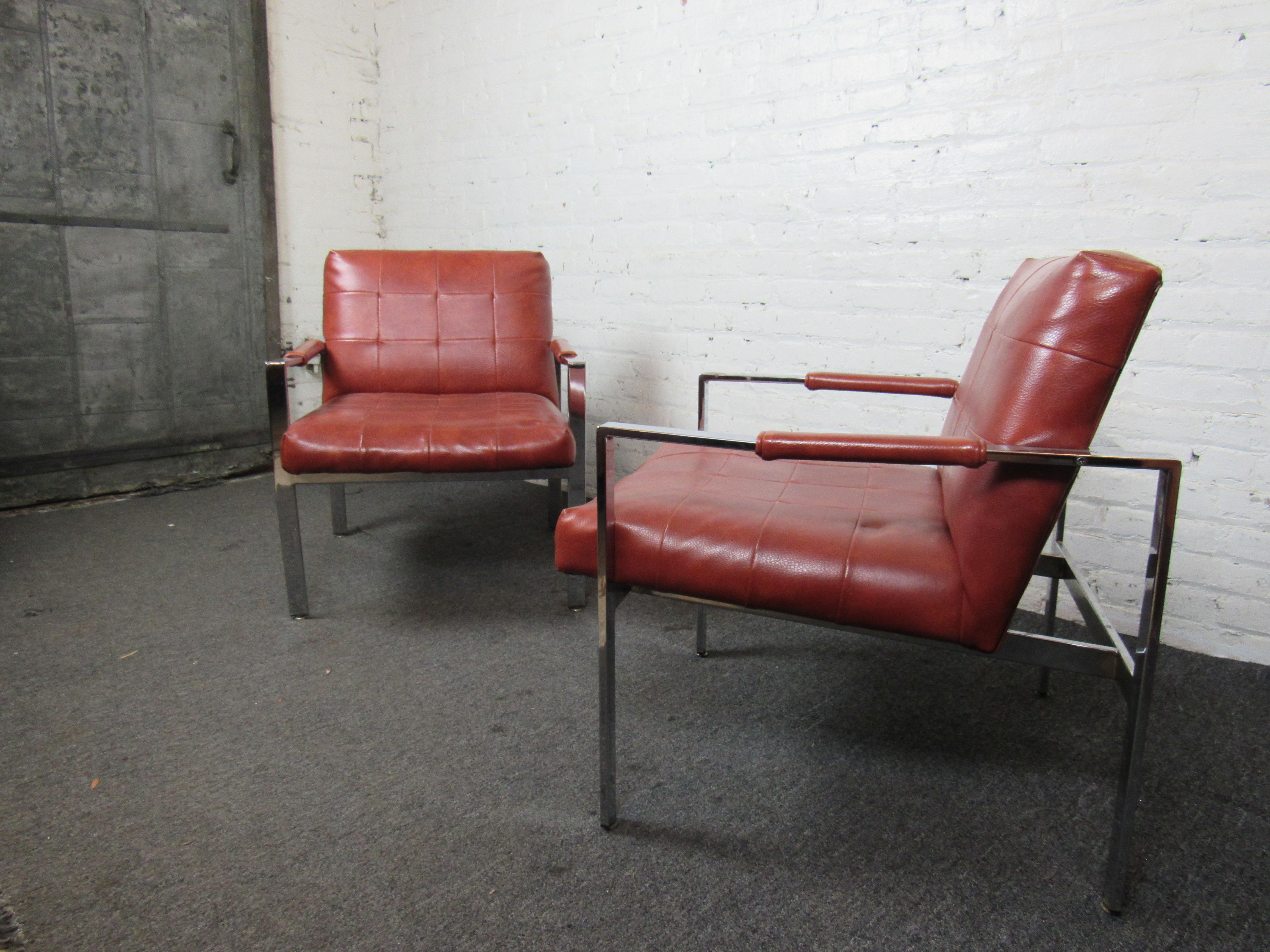 This vintage pair of armchairs combine chrome frames with rich brick-red fabric and a stylish design. Perfect for any office, lobby, or home, this Mid-Century Modern pair is sure to add character and style to any space. 

Please confirm item