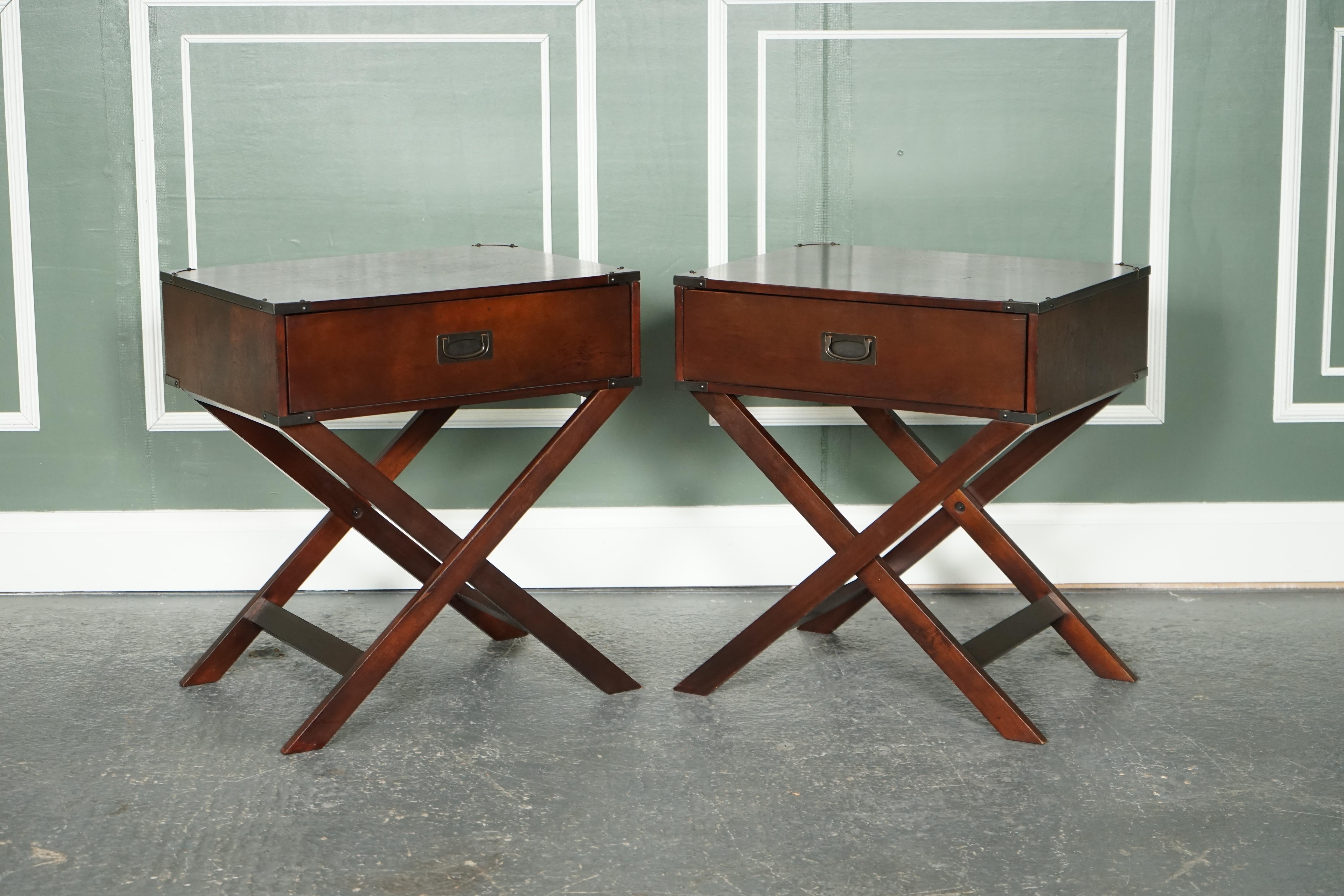 We are excited to present this vintage pair of military campaign-style bedside end tables.

Very good-looking pair raised on x-framed legs.
Campaign handles and brackets around the corners.

We have deep cleaned, stained, hand waxed and hand
