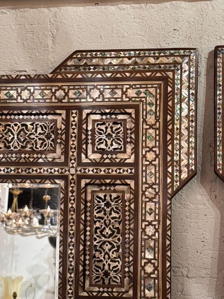 La paire de miroirs Eleg vintage présente une incrustation complexe de nacre, ce qui leur confère une touche d'élégance et de sophistication. Les miroirs ont un aspect décoratif qui rehausse leur attrait, ce qui en fait un ajout charmant à tout