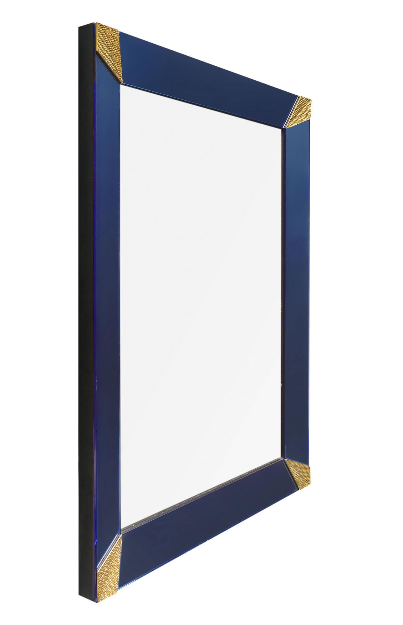 A pair of Murano glass grand mirrors made of blue glass with gold textured triangular corner elements. Can be sold separately upon request.