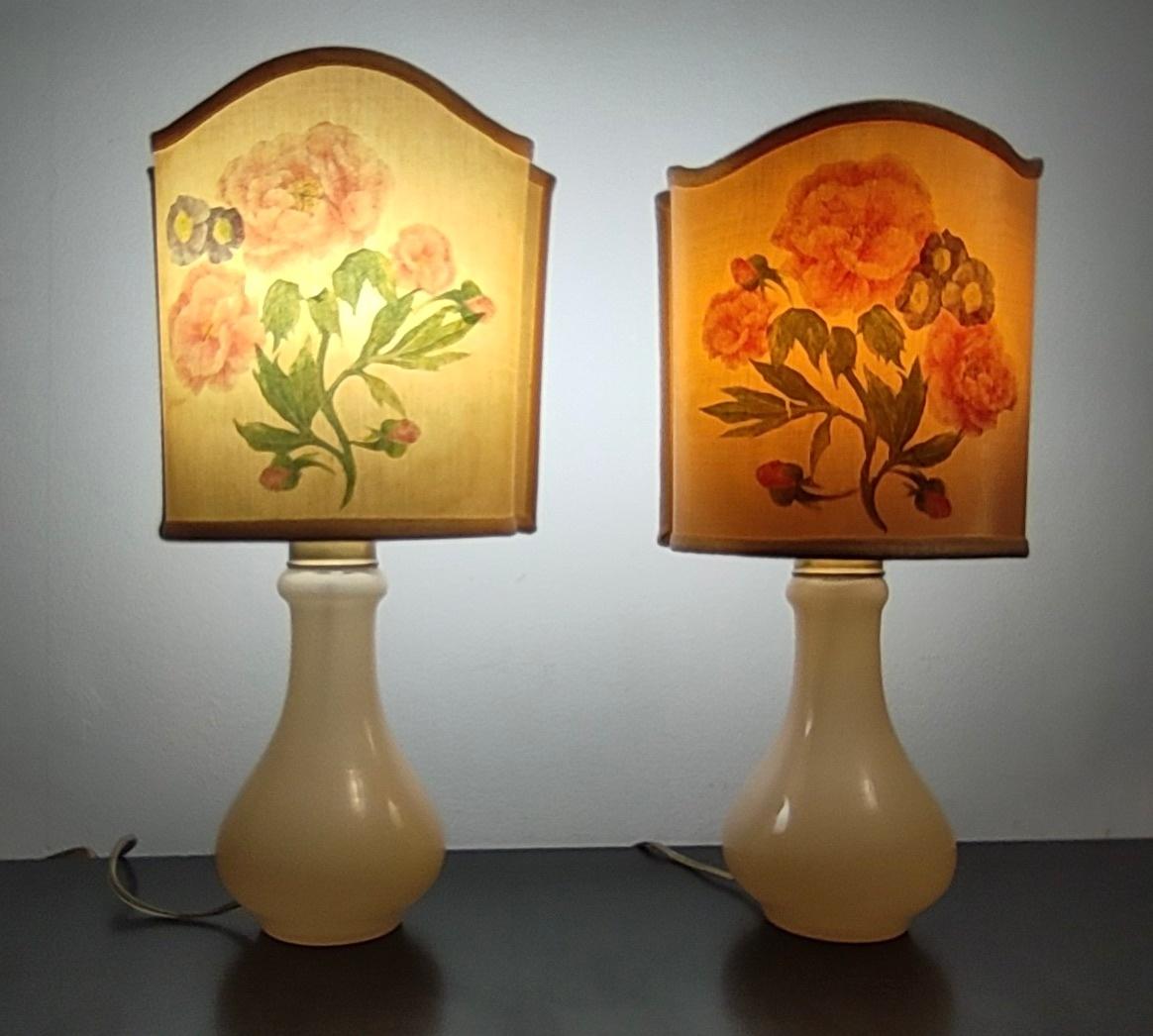 Made in Italy, 1960s
These table lamps are made in Murano glass with brass elements. 
They feature a flower design on the fabric lampshades.
These lamps might show slight traces of use since they're vintage, but they can be considered as in