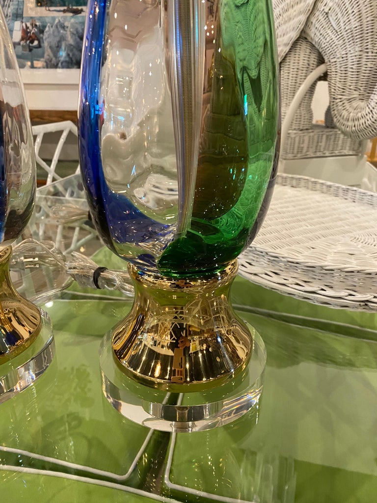 The most amazing pair of Murano Italian glass table lamps. These have been completely restored to perfection! Large glass lamps with cobalt blue, Kelly green and amethyst stripe. Cobalt blue matching glass blown finial. Lucite base with original