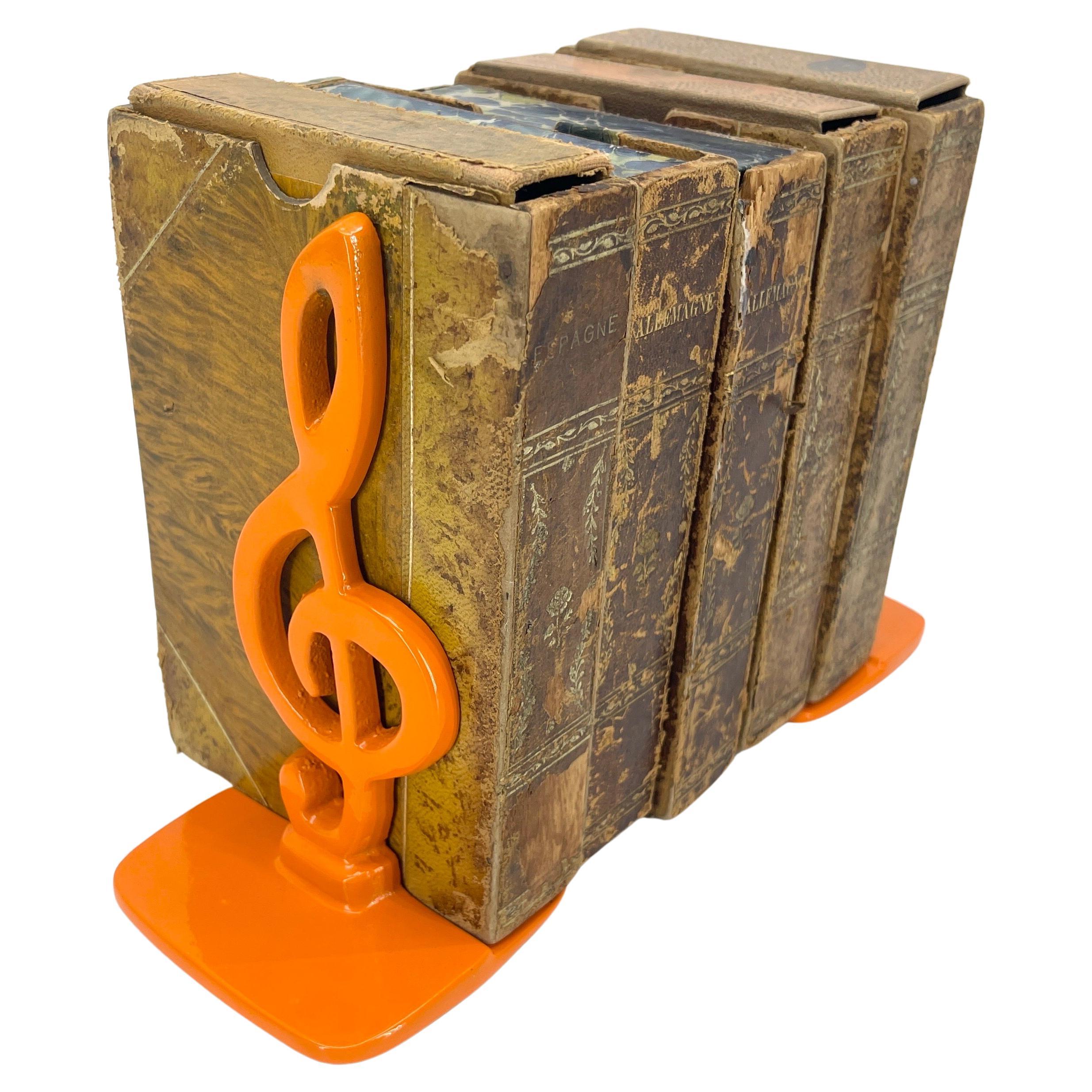 Powder-Coated Orange Set of Music Note Bookends

Pair of vintage brass bookends in newly powder-coated orange. This pair are classic music notes on a square base. Absolutely one of a kind, these bookends will accentuate your home on a bookcase,