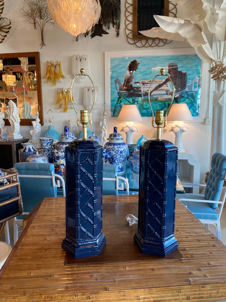 Vintage pair of Chinese chippendale navy blue faux bamboo ceramic table lamps. No chips or breaks. Newly wired with new brass hardware and 3 way sockets. Dimensions 23.5 H to socket x 30 H to finial x 7 D x 8 W