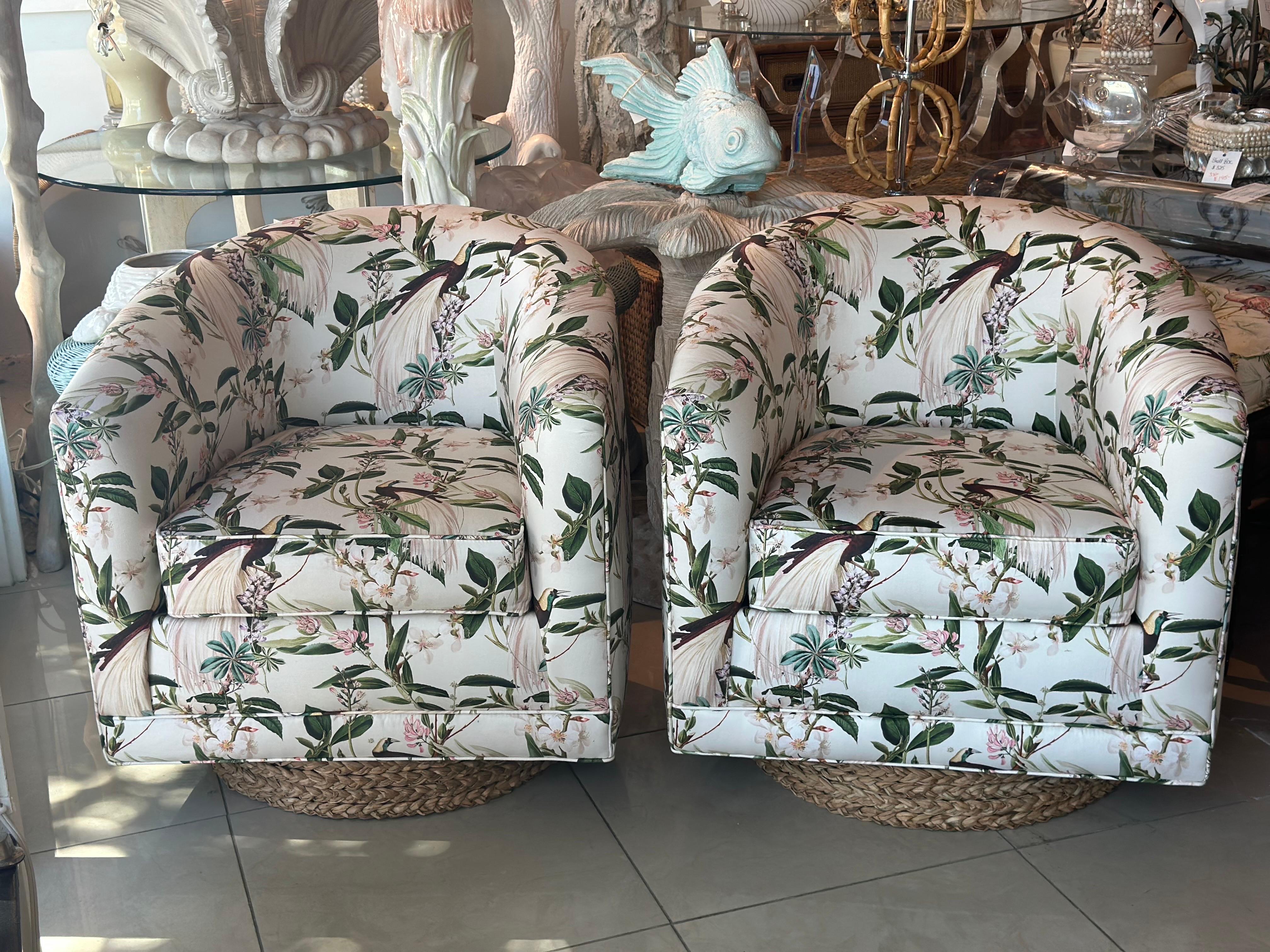 Most amazing pair of vintage 1970s swivel chairs in the style of Milo Baughman. These have been newly upholstered in a bird botanical fabric with a seagrass platform base. Dimensions: 31 H x 29 W x 25 Overall Depth, Seay Height 18. 