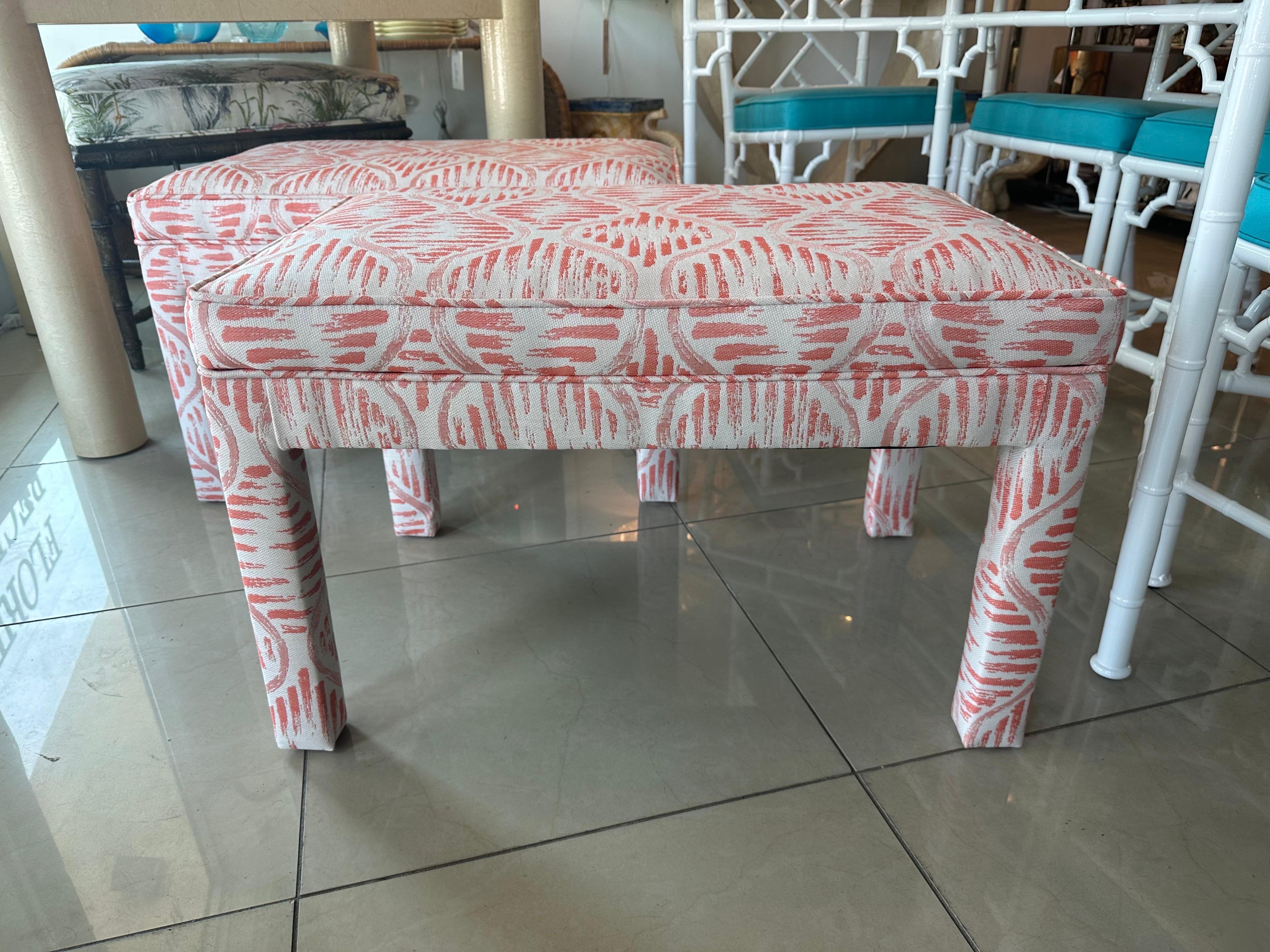 Vintage pair of 1970s parsons stools, benches, ottomans. Newly upholstered in a. fabulous coral fabric. Dimensions: 18.5 H x 29 W x 18.5 D.