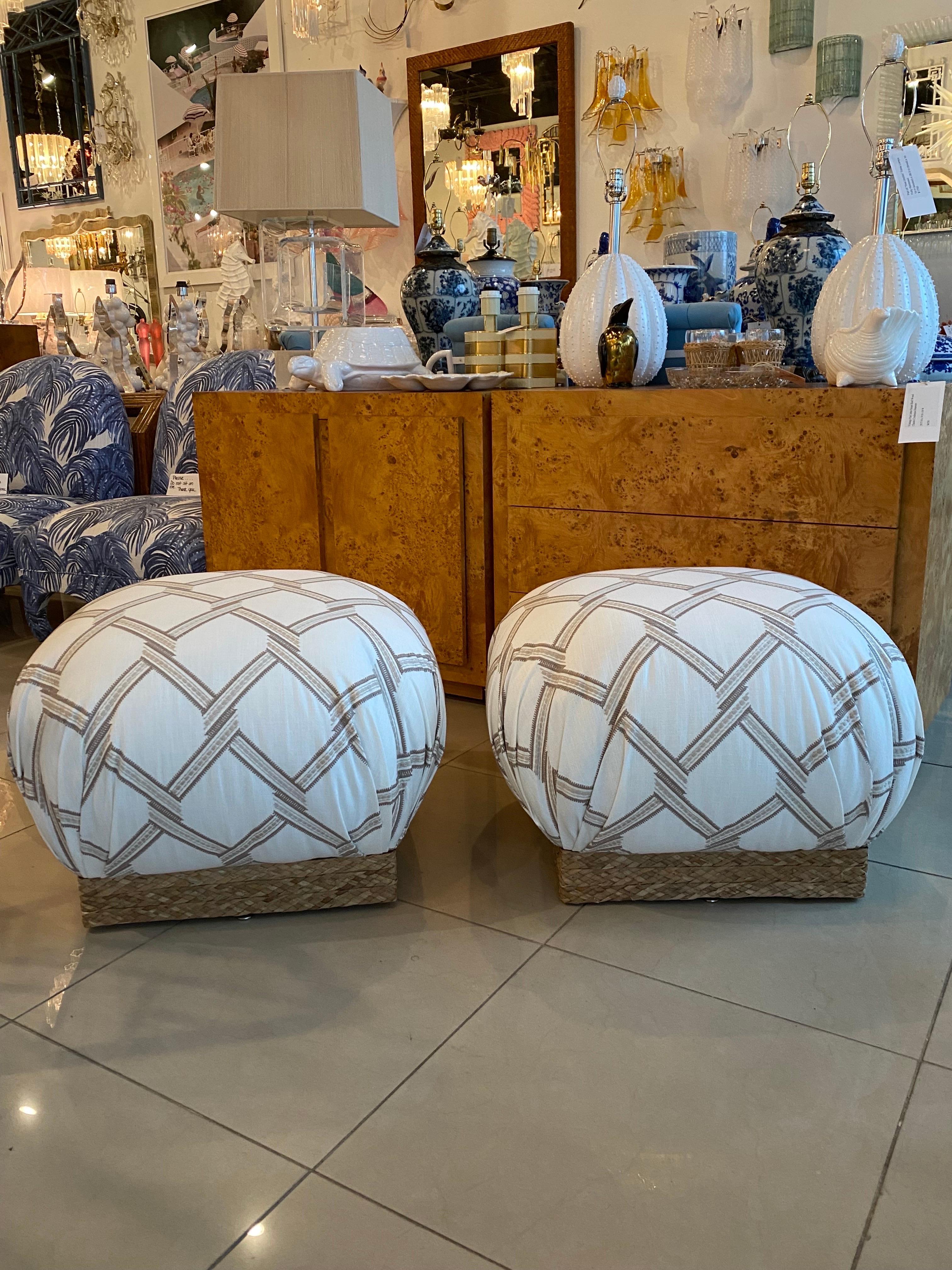 Beautiful vintage pair of newly upholstered poufs with seagrass base. In the style of Karl Springer. Dimensions: 18 H x 26 W x 26 D.
