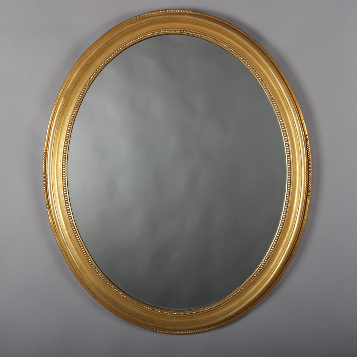 Vintage pair of matching oval wall mirrors feature stepped and beaded giltwood frames, 20th century.

Measures: Overall 35