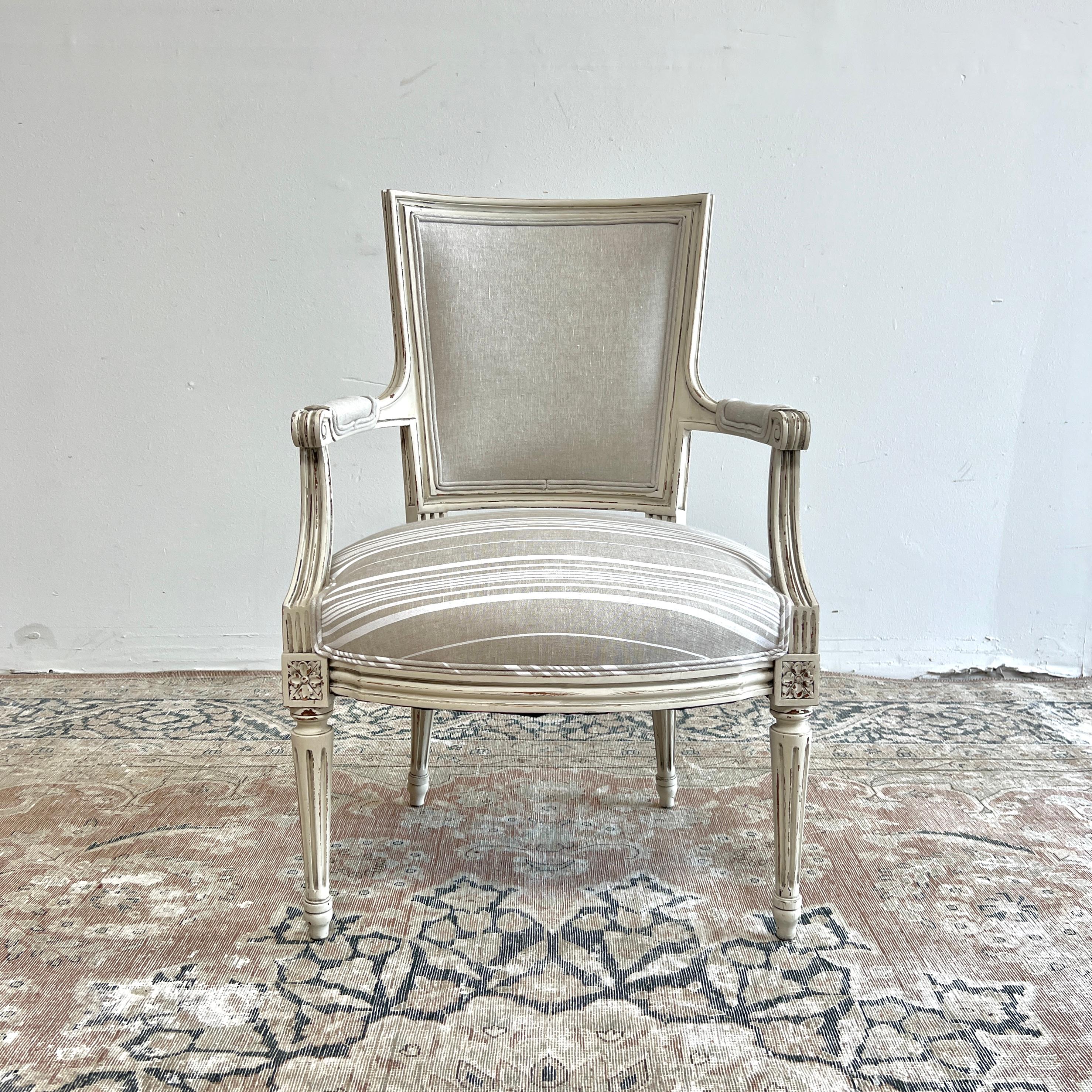 Pair of vintage french style open arm chairs painted in our antique white with subtle distressed edges, and antique patina.
Upholstered in a french stripe linen and natural oatmeal linen.
Size:
22.5