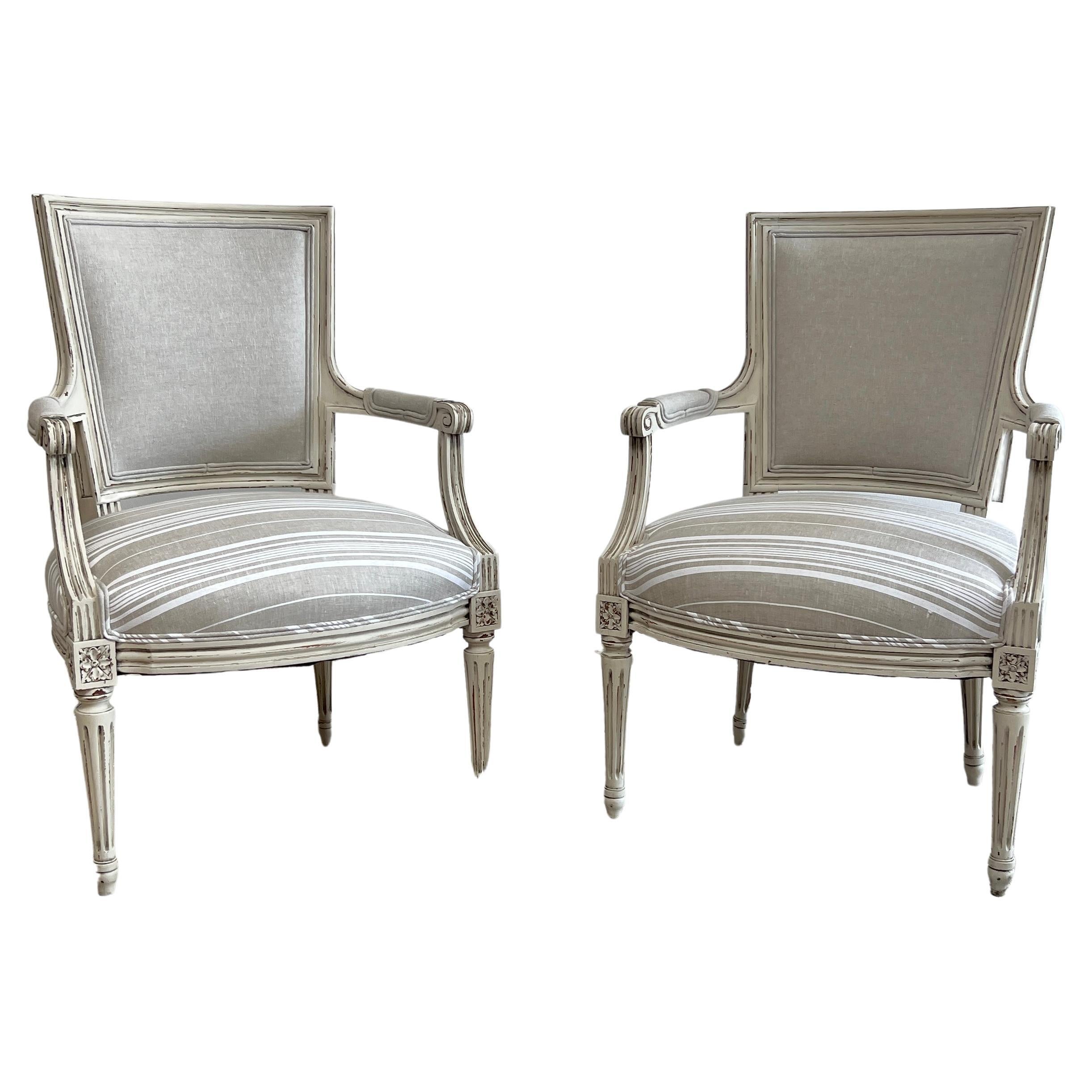 Vintage Pair of Painted and Upholstered French Louis XVI Style Open Arm Chairs For Sale