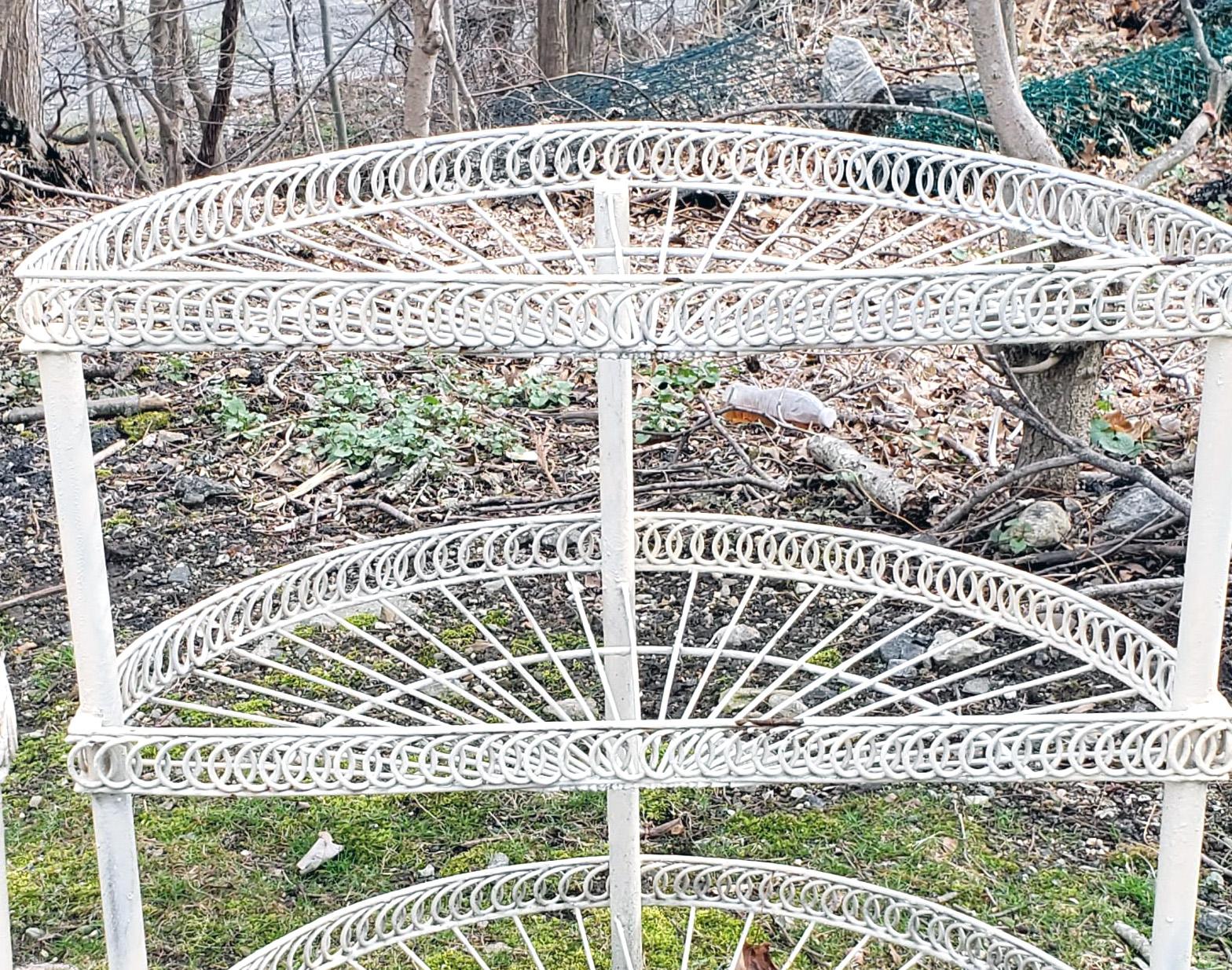 Pair of painted wire Demilune flower stands
circa 1930-1950

The pair of Demilune-shaped white paint wire flower stands have a double layer with the top having a raised edge.

Dimensions: 31 inches high x 30 inches wide x 15 .5 inches.