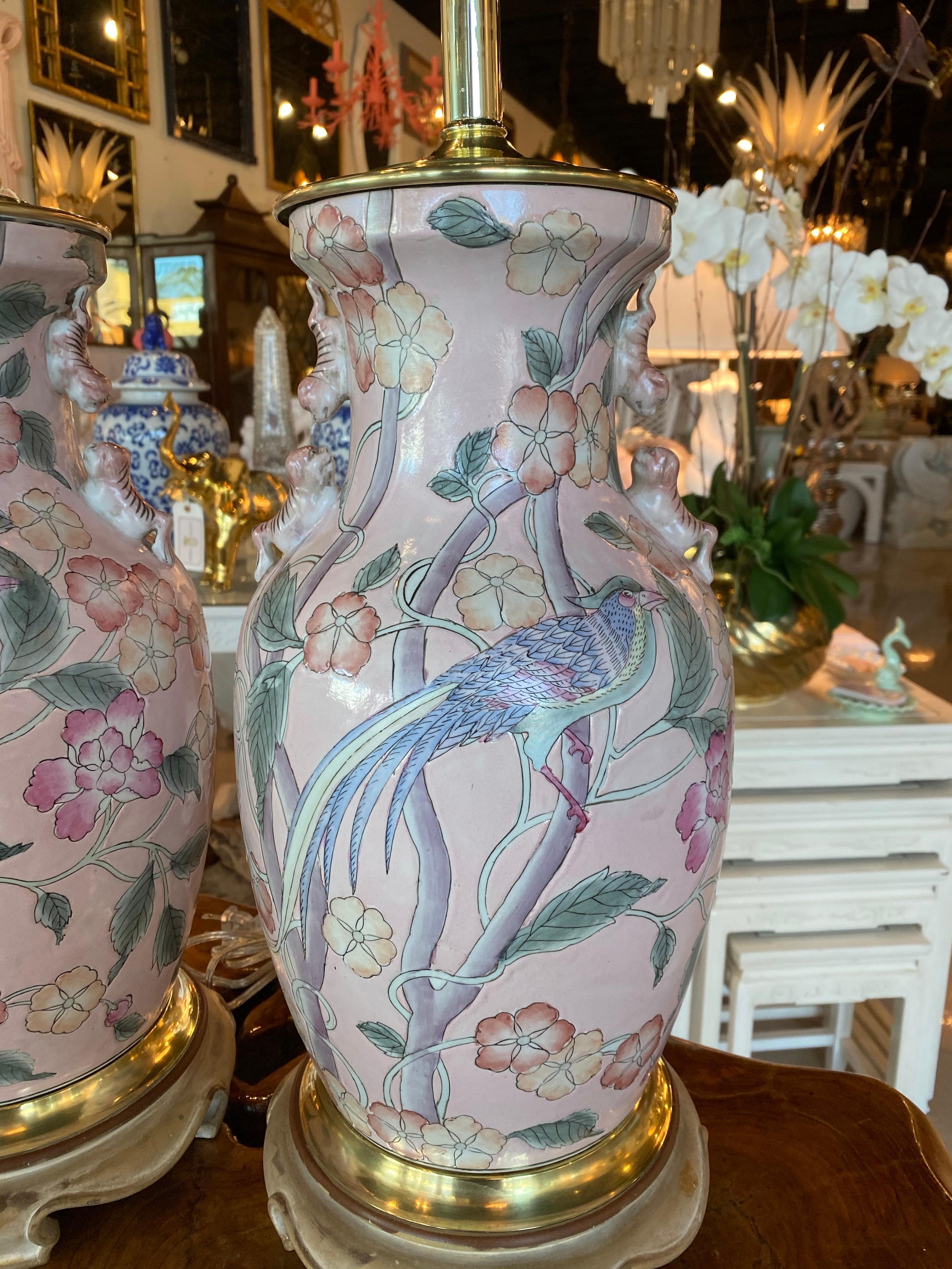 Vintage pair of pale pink chinoiserie ginger jar table lamps. Bird and floral design. Brass has been polished. Lamps have been newly wired, all new brass hardware, 3 way socket. No chips or breaks. 
Measures: 23