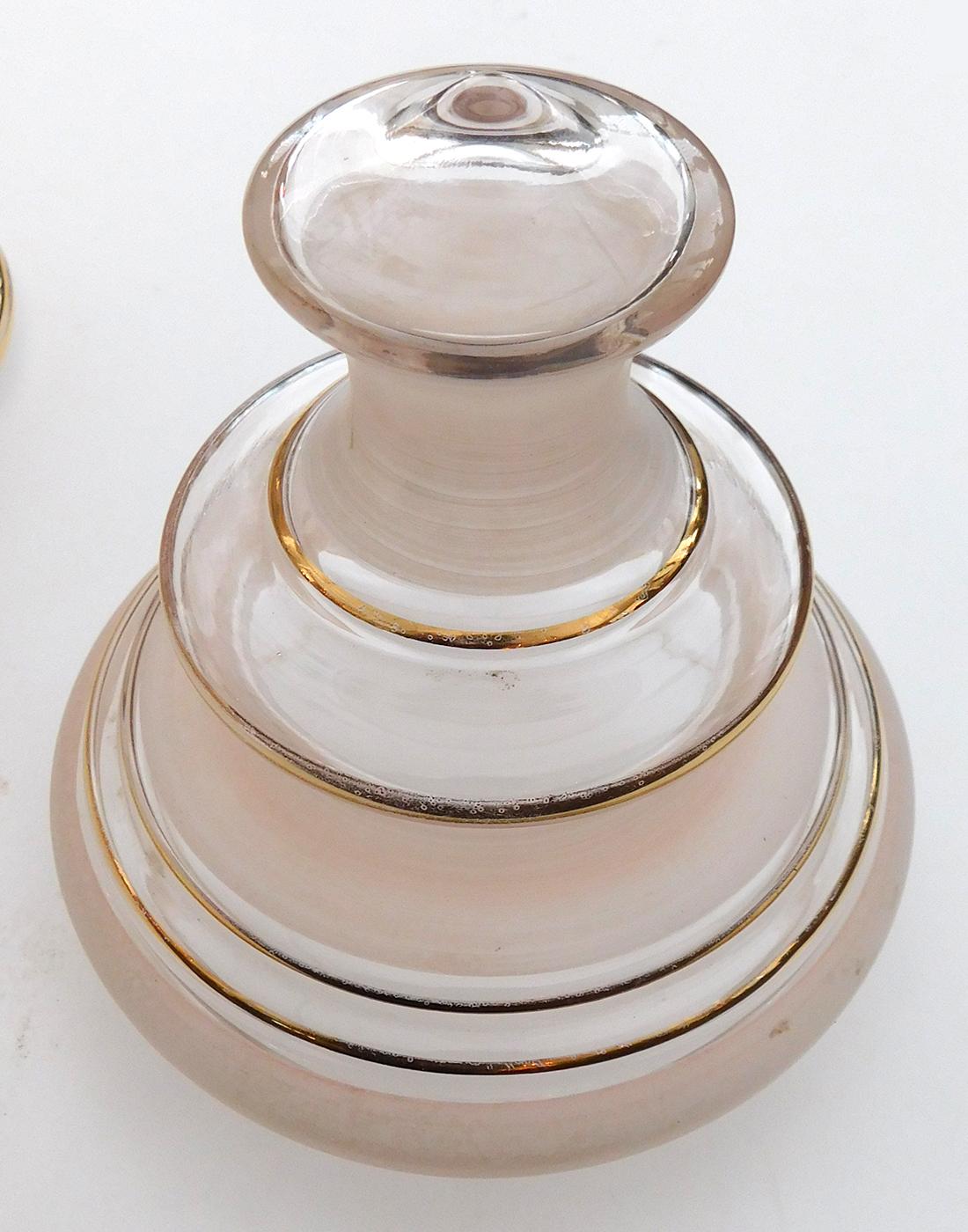 each with shaped lid over a cylindrical body all in alternating clear and frosted glass with hand-painted foliate perimeter bands with gilt highlights; overall even wear with rubbing to gilded surface.